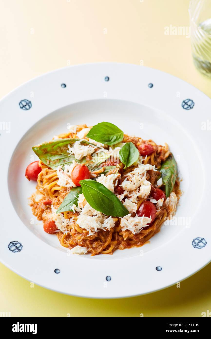 Spaghetti with tomato ragout, parmesan, and basil Stock Photo - Alamy