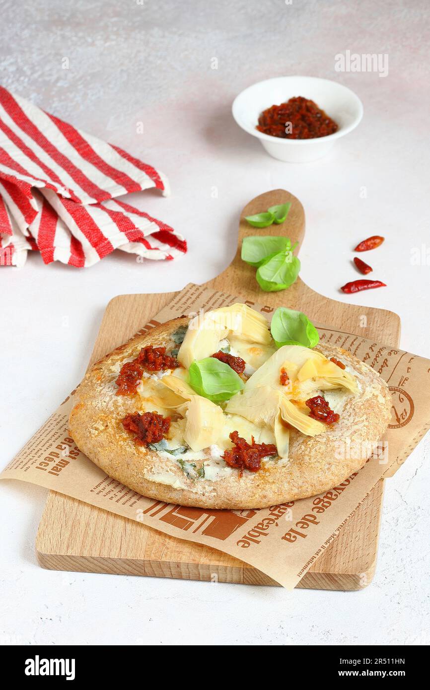 Pizza with mozzarella, ricotta and artichokes Stock Photo Alamy