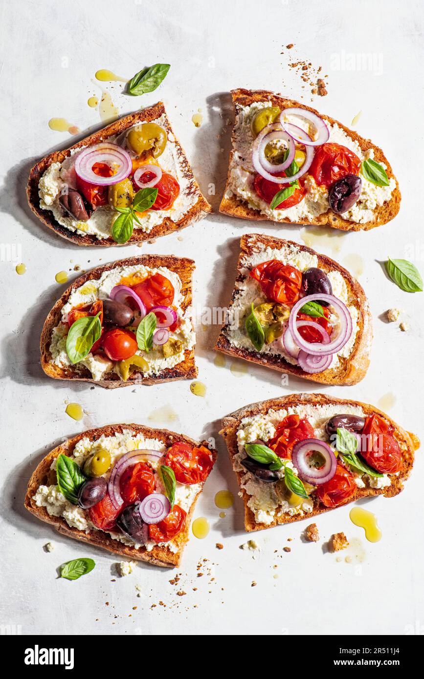Sourdough bread topped with homemade ricotta and roasted tomatoes Stock