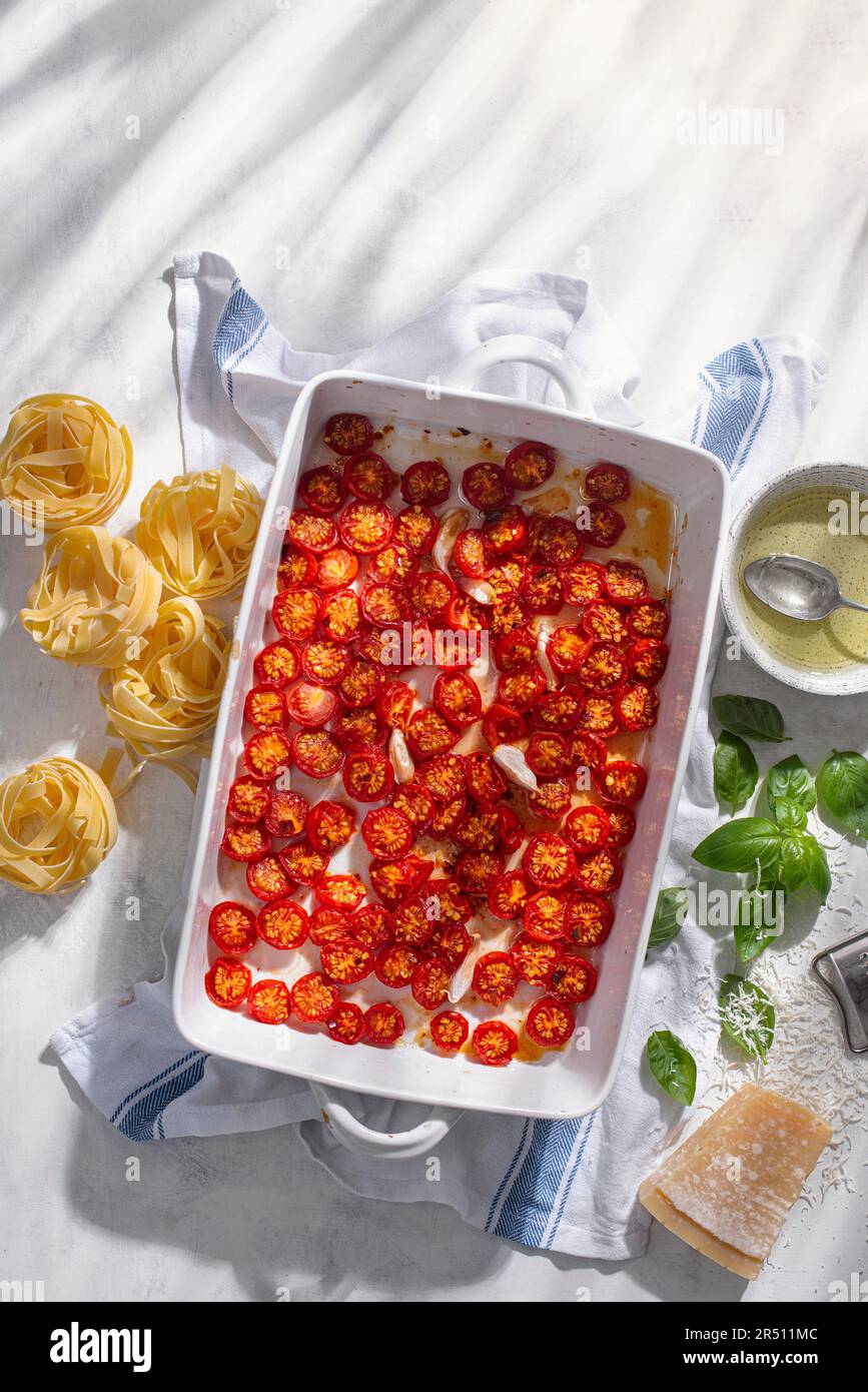 Roasted cherry tomatoes in a casserole dish Stock Photo