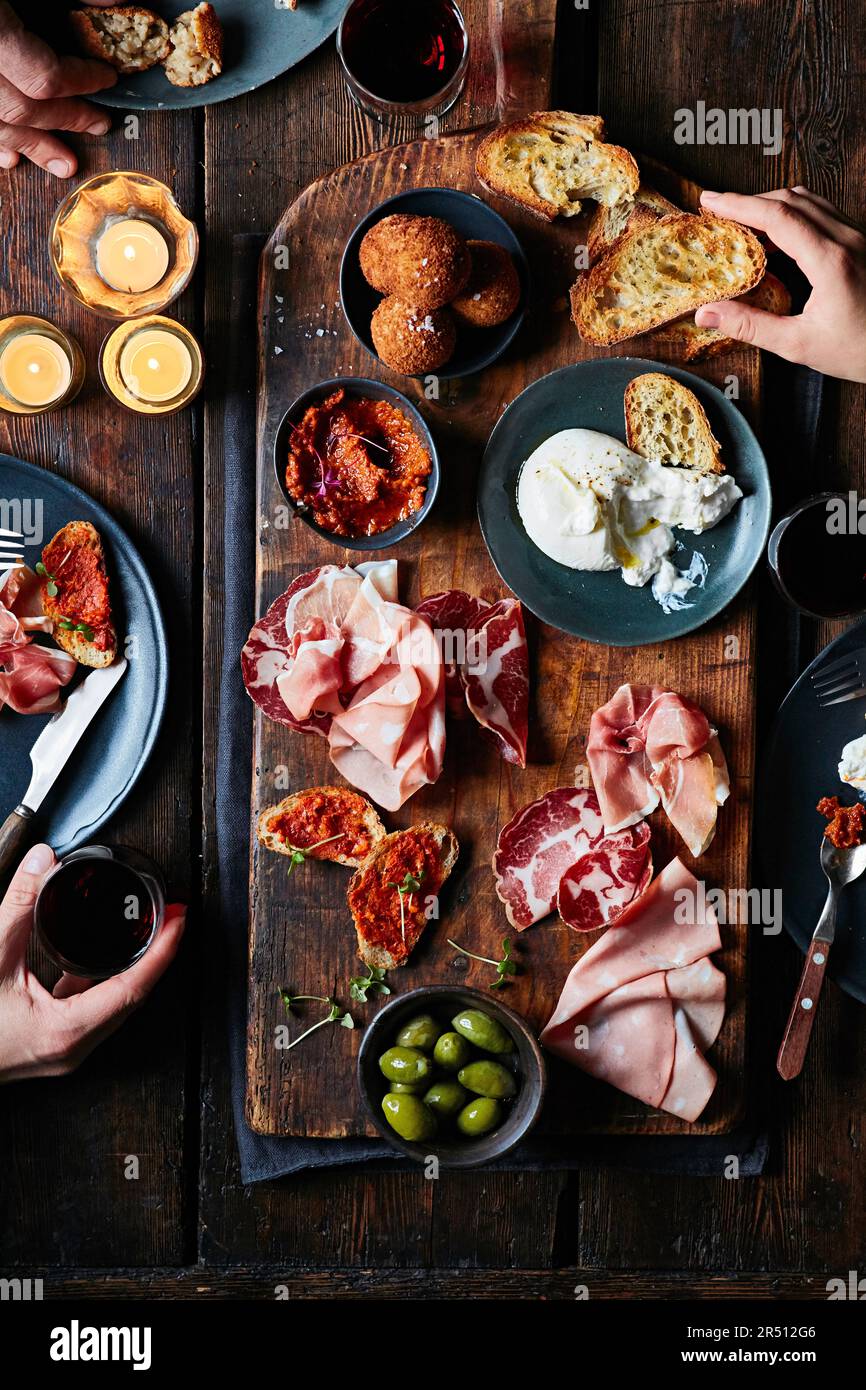 Cold cuts platter with burrata, olives and mini arancini Stock Photo