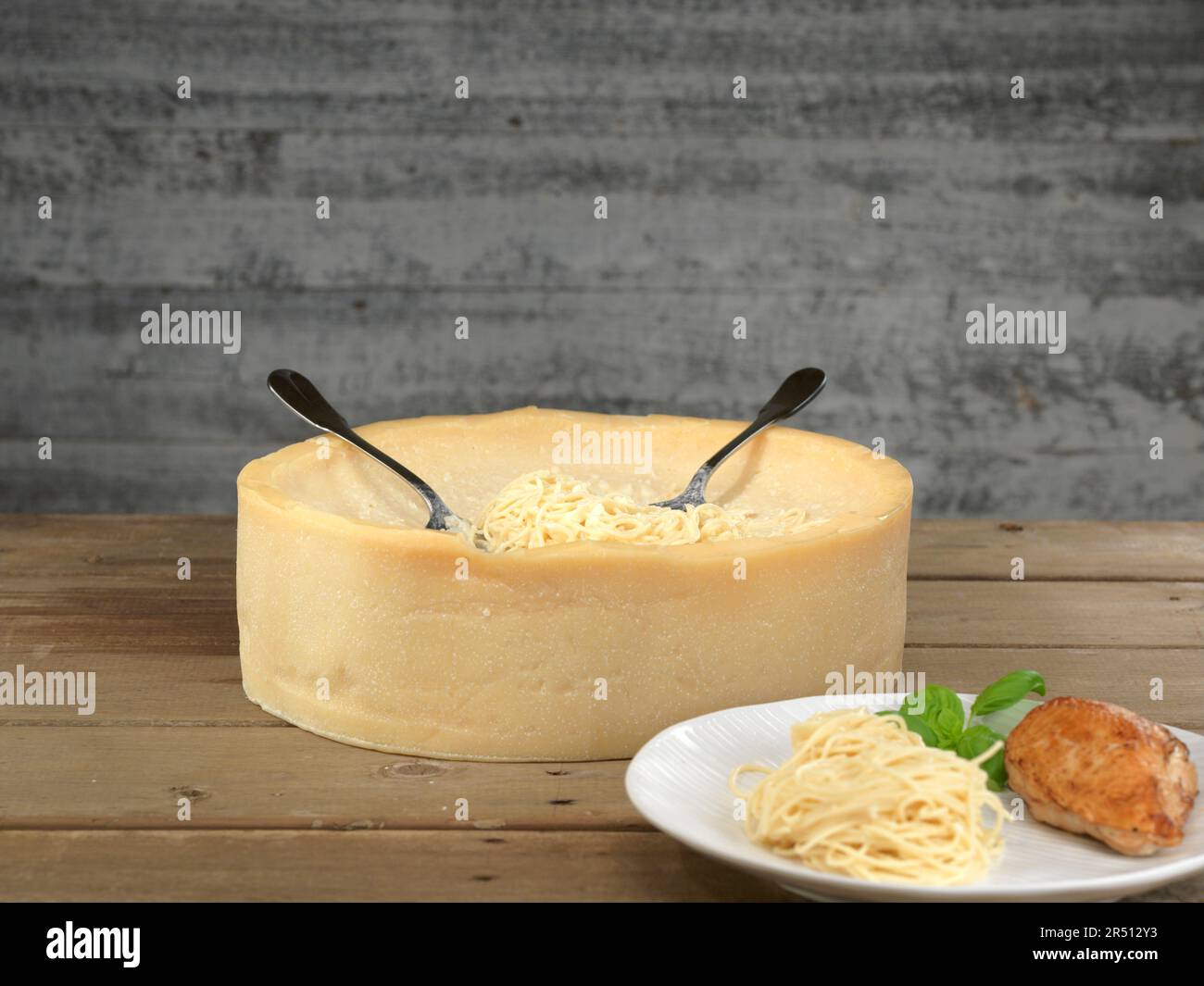 Parmesan wheel with spaghetti Stock Photo Alamy