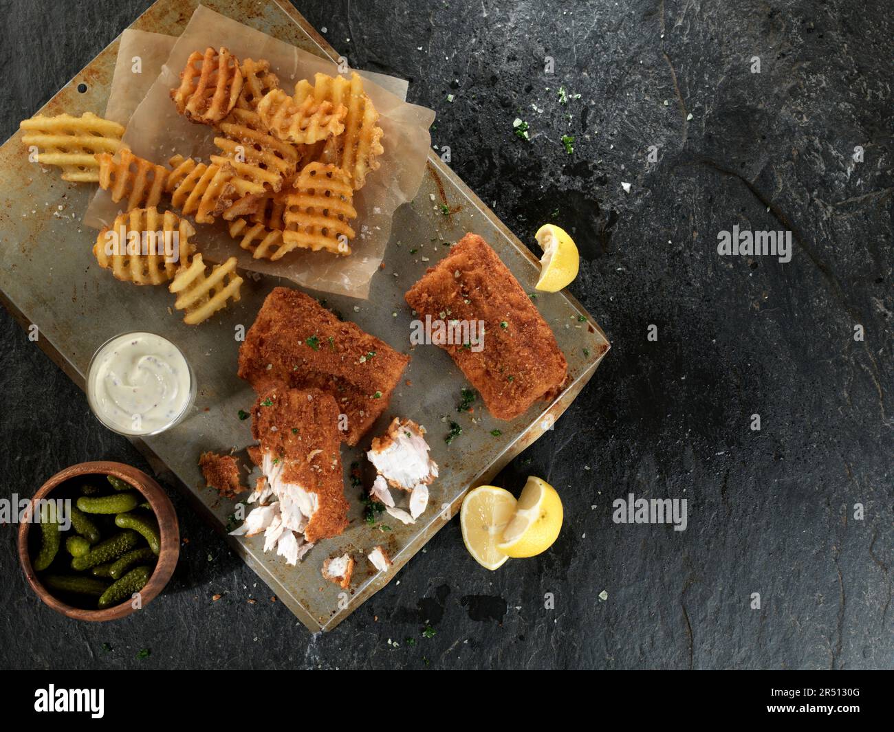 Fish in a pretzel coating with lattice potatoes Stock Photo - Alamy