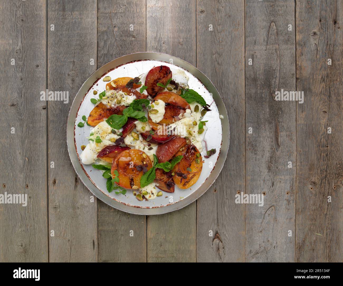 Grilled Peaches and plums with Burrata Stock Photo Alamy