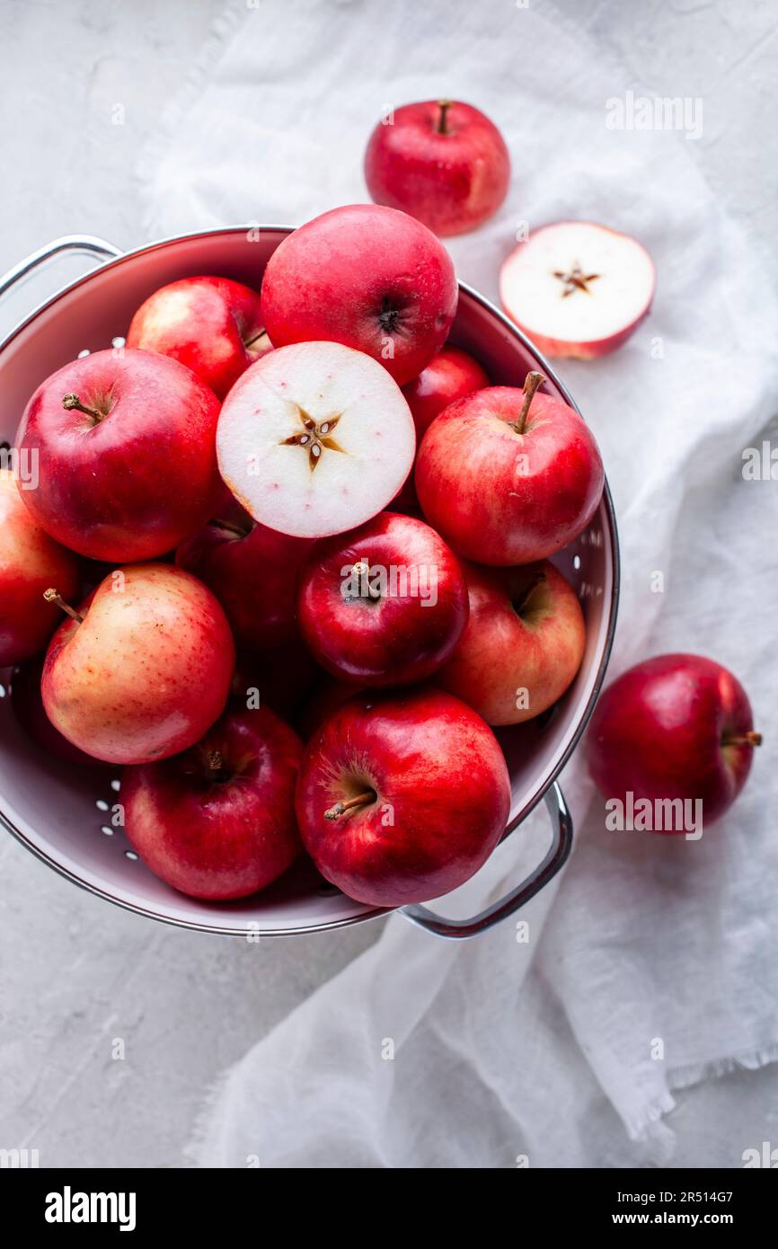 Fresh red apples in a colander Stock Photo - Alamy