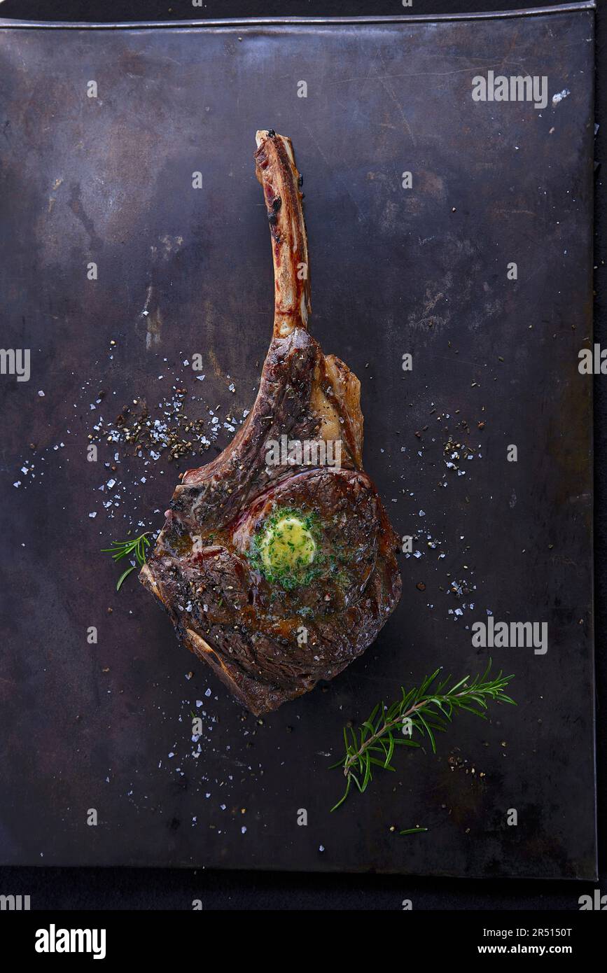 Grilled tomahawk steak with herb butter Stock Photo