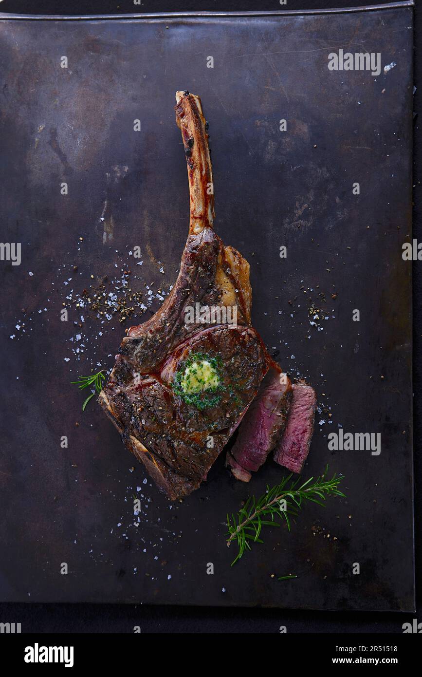 Grilled tomahawk steak with herb butter Stock Photo Alamy
