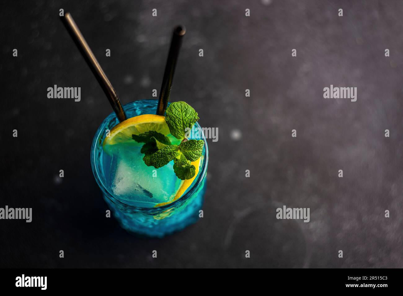 Cocktail high glass with blue kamikaze drink decorated with fresh mint ...