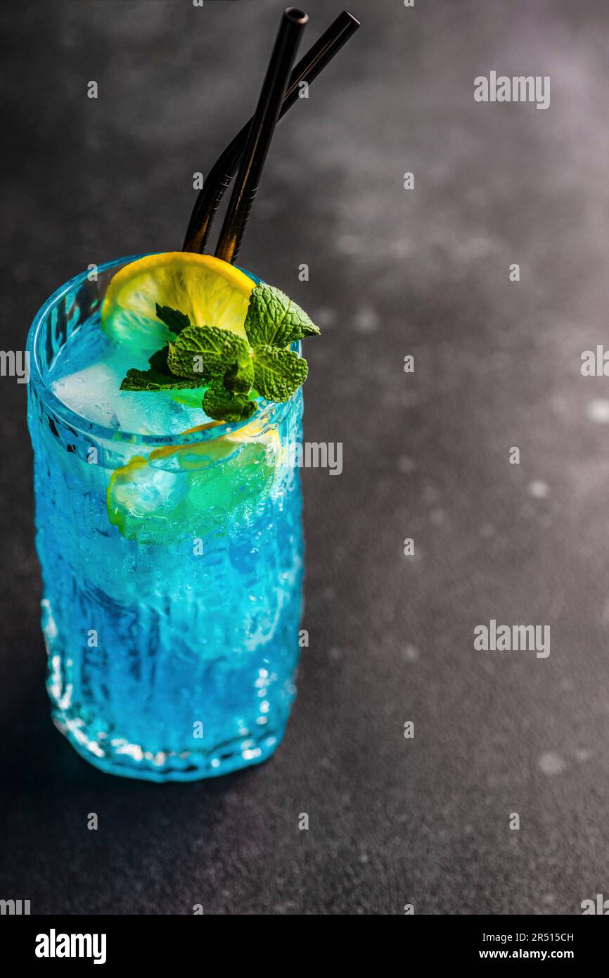 Blue kamikaze drink decorated with fresh mint and a slice of lemon ...