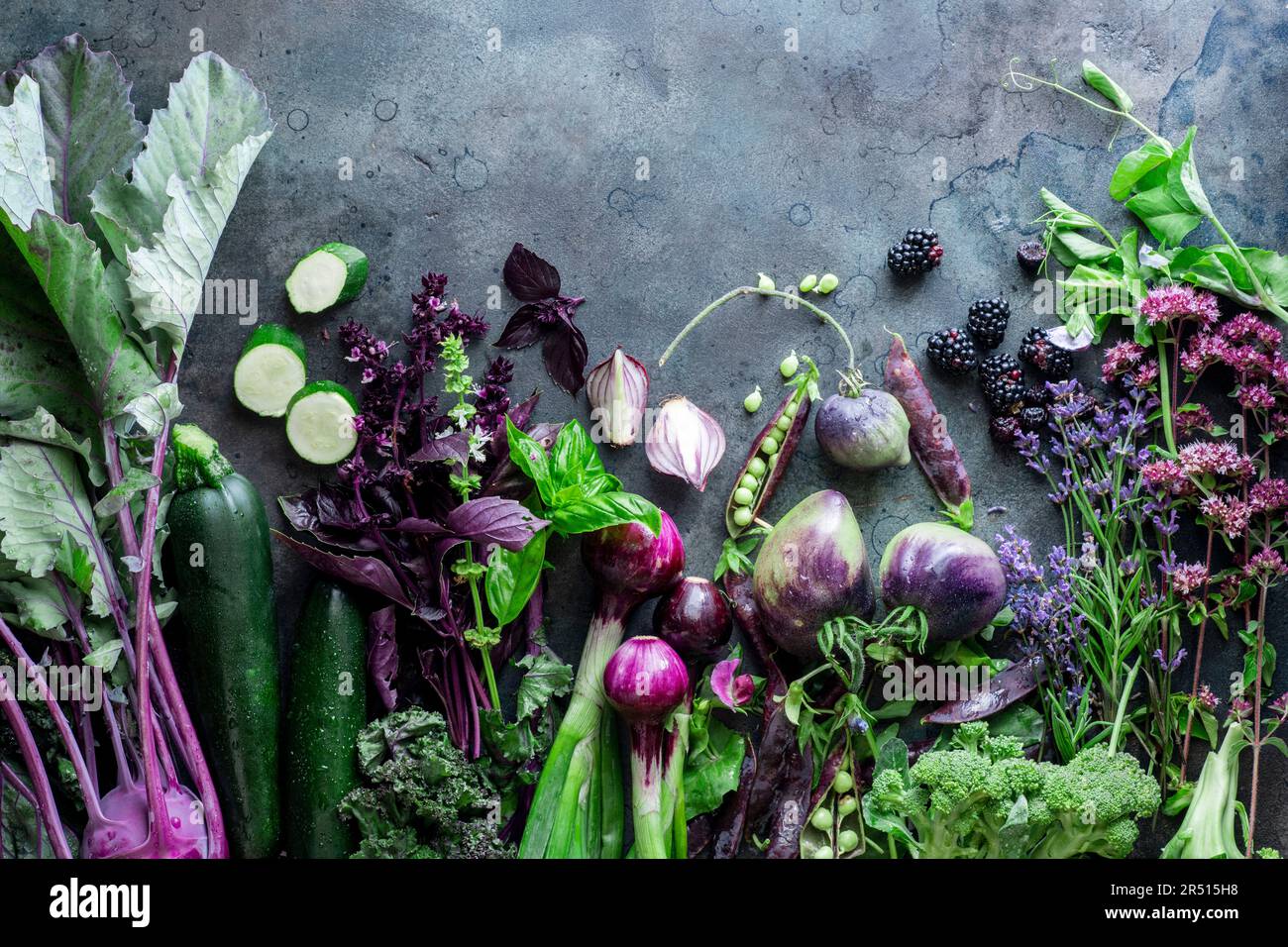 Still life with vegetables in purple and green Stock Photo - Alamy