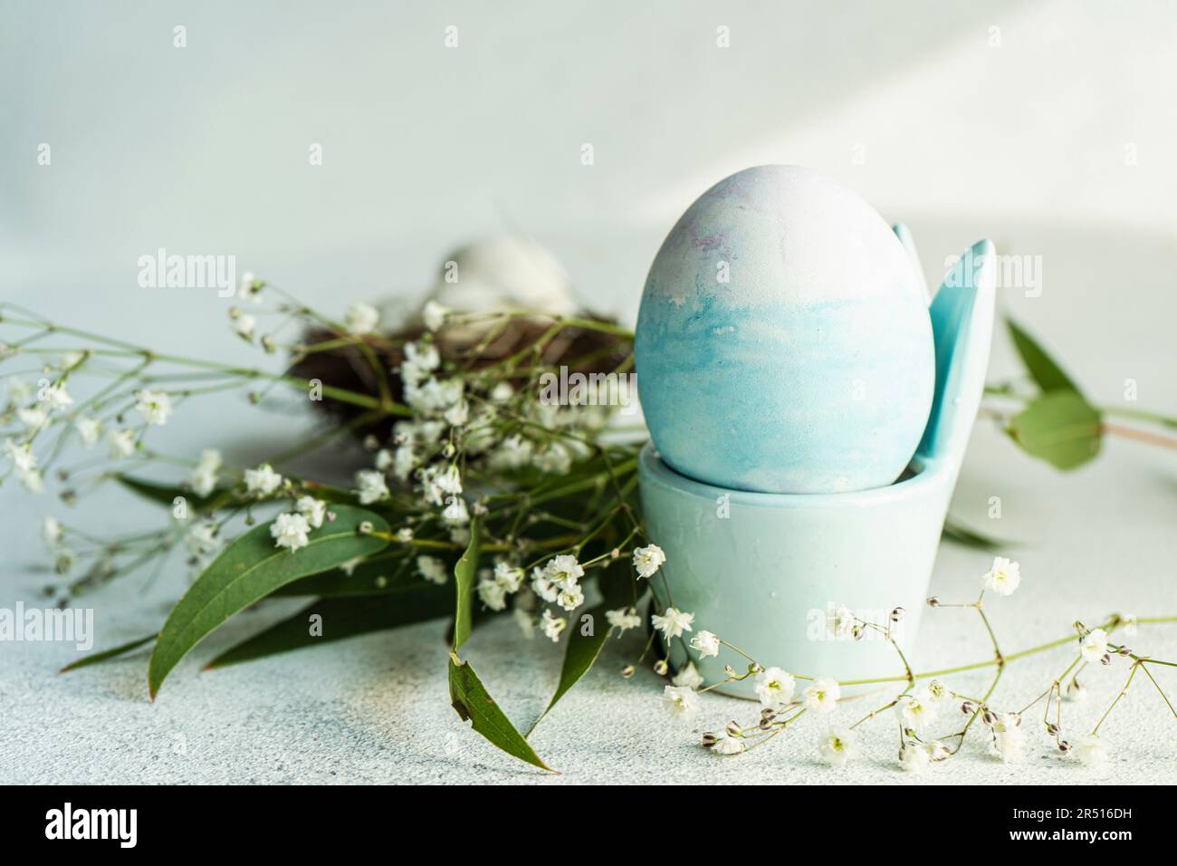 Blue coloured egg in an Easter egg cup Stock Photo