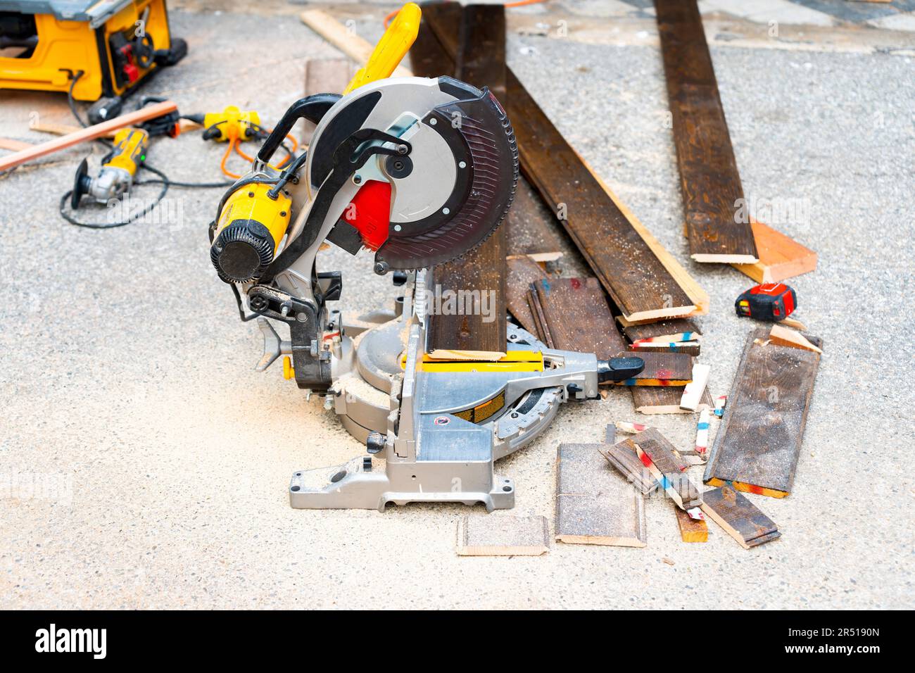 Freshly cut flooring wood planks by a sliding compound miter saw