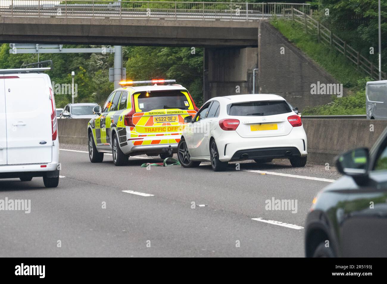 Breakdown in outside lane of M1 smart motorway.  Broken down car with Traffic Officer vehicle in attendance with tow rope - England, UK Stock Photo