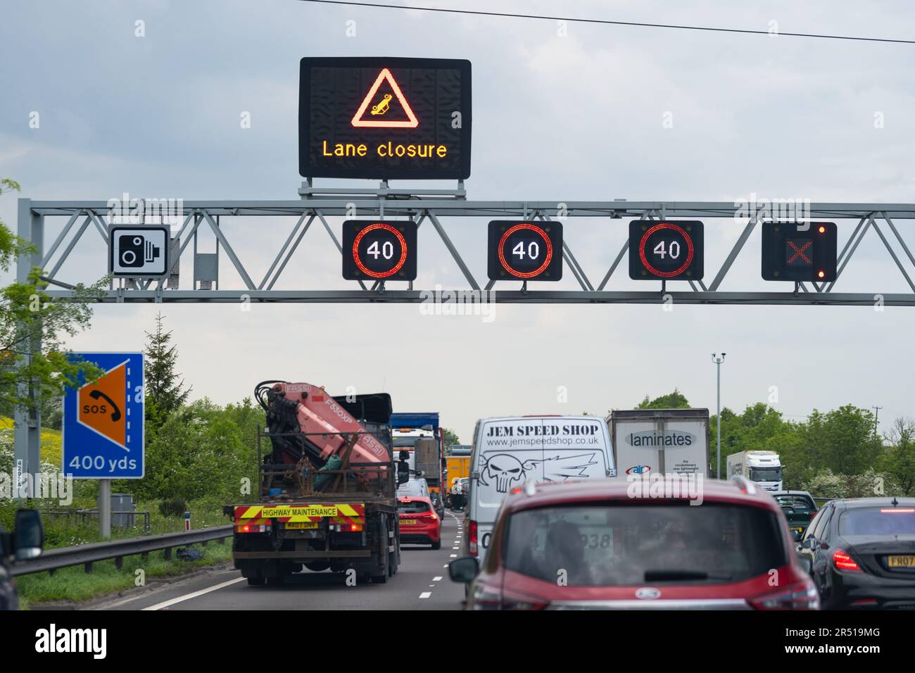 Smart motorway lane closure overhead gantry signs showing accident or breakdown in live outside lane which has been closed - M1 motorway England, UK Stock Photo