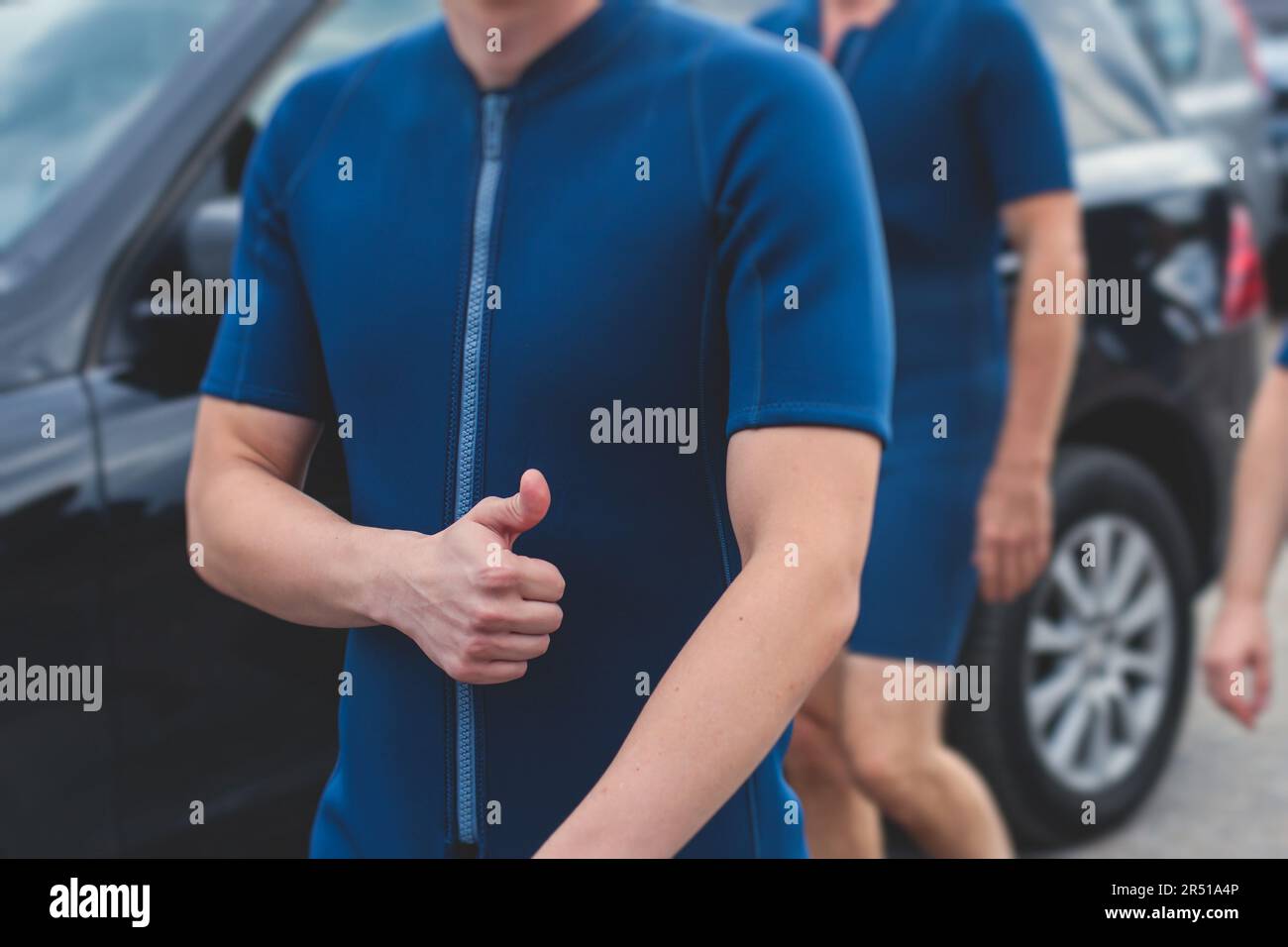 Group of sportsmen in wetsuits with paddles in helmets and life jackets