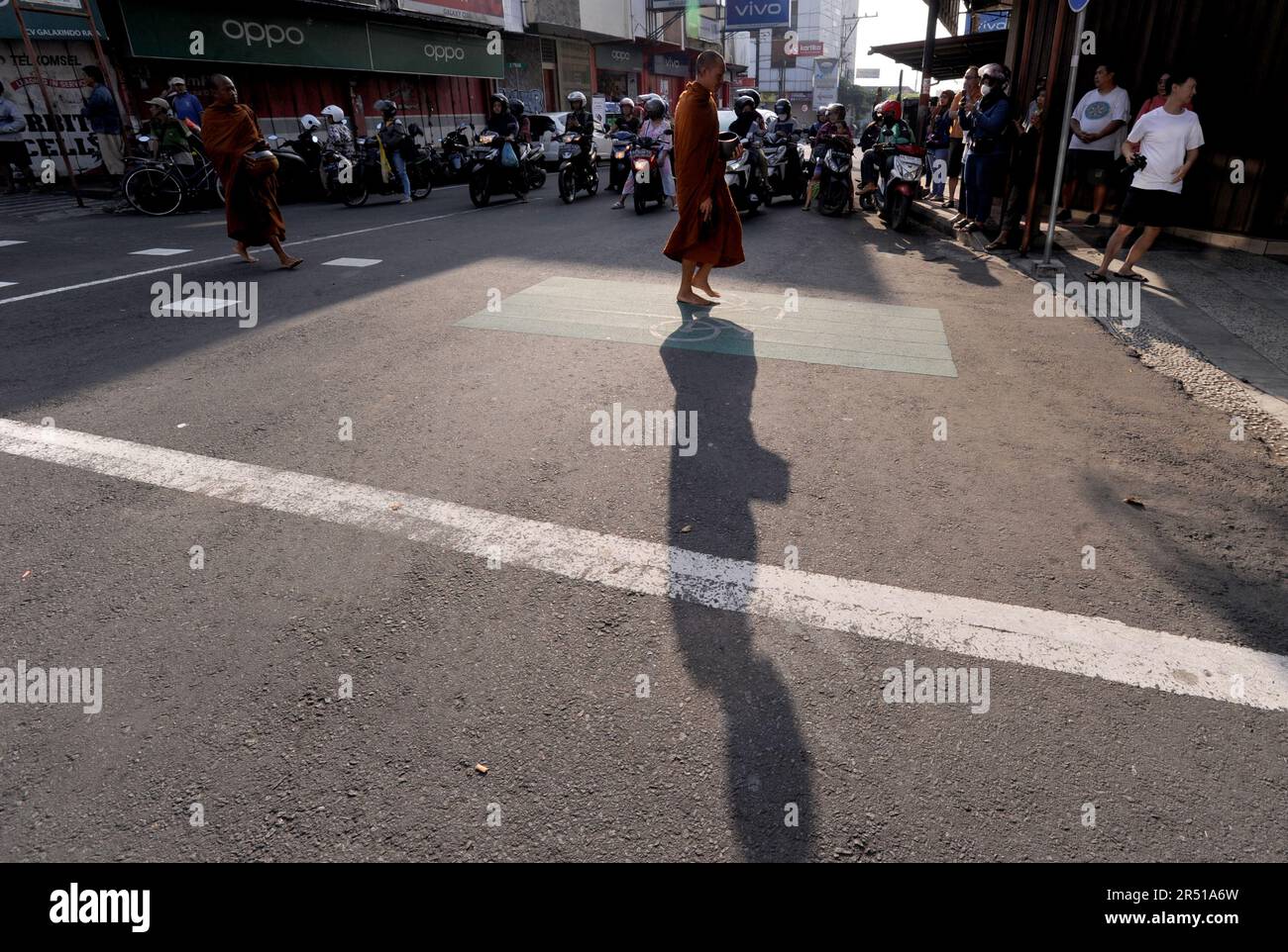 May 31, 2023, Magelang, Central Java, Indonesia: Monks from Thailand, Singapore, Malaysia, Indonesia who perform the Thudong ritual on foot to Borobudur Temple, go for alms at the Liong Hok Bio Temple in Magelang, Central Java, on May 31 2023. In Magelang City, the monks received a friendly welcome from the locals. around waiting on the side of the road for the Pindapata tradition which was stopped for 3 years, Pindapata is a Buddhist tradition of giving alms to monks or priests in the form of food, money, and various daily needs. The 32 monks are scheduled to continue their final journey to B Stock Photo