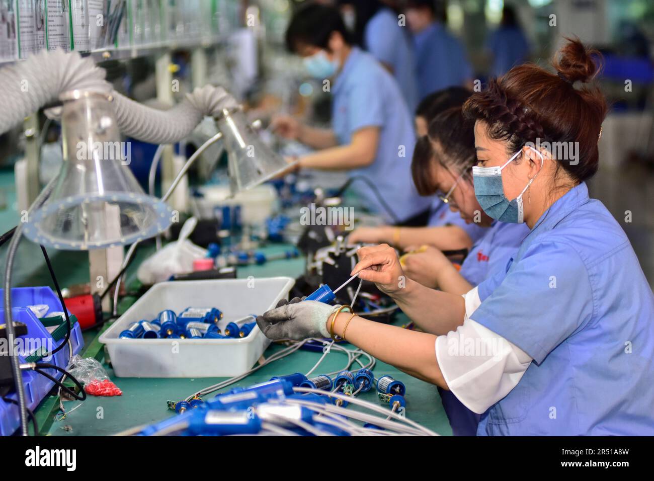 QINGZHOU, CHINA - MAY 31, 2023 - Workers assemble products on a ...