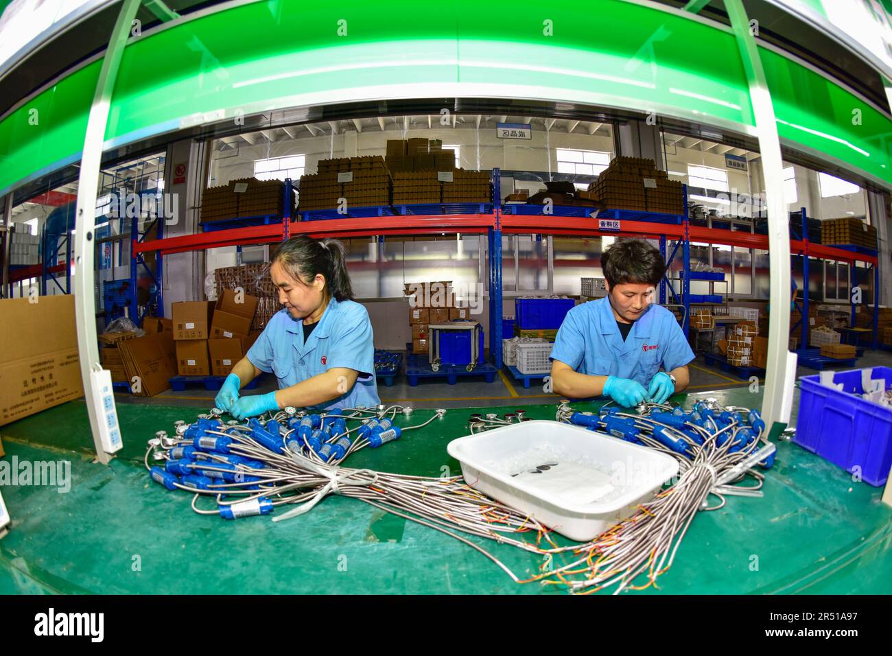 QINGZHOU, CHINA - MAY 31, 2023 - Workers assemble products on a ...