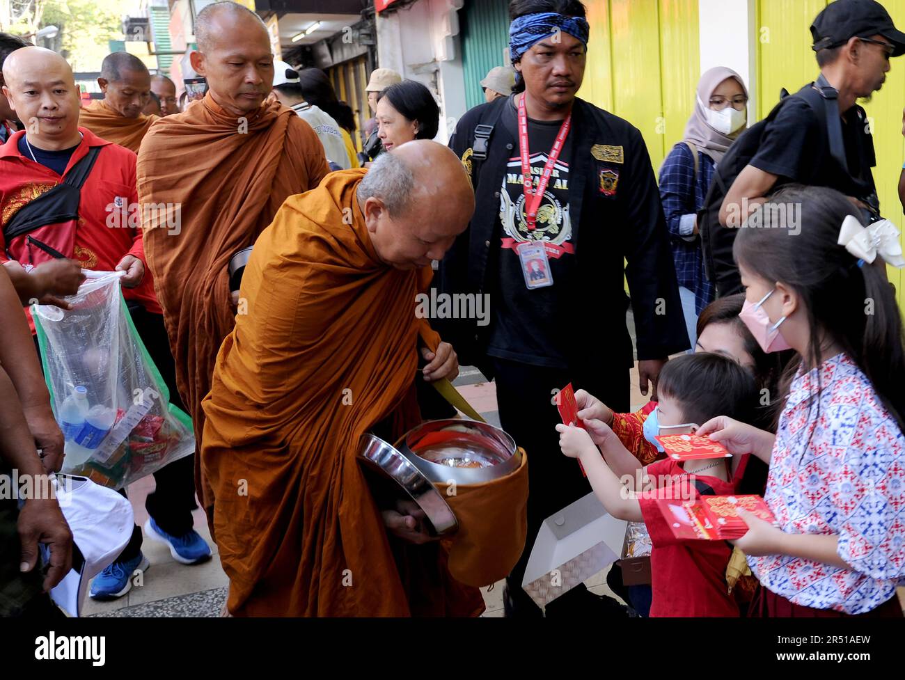 May 31, 2023, Magelang, Central Java, Indonesia: Monks from Thailand, Singapore, Malaysia, Indonesia who perform the Thudong ritual on foot to Borobudur Temple, go for alms at the Liong Hok Bio Temple in Magelang, Central Java, on May 31 2023. In Magelang City, the monks received a friendly welcome from the locals. around waiting on the side of the road for the Pindapata tradition which was stopped for 3 years, Pindapata is a Buddhist tradition of giving alms to monks or priests in the form of food, money, and various daily needs. The 32 monks are scheduled to continue their final journey to B Stock Photo
