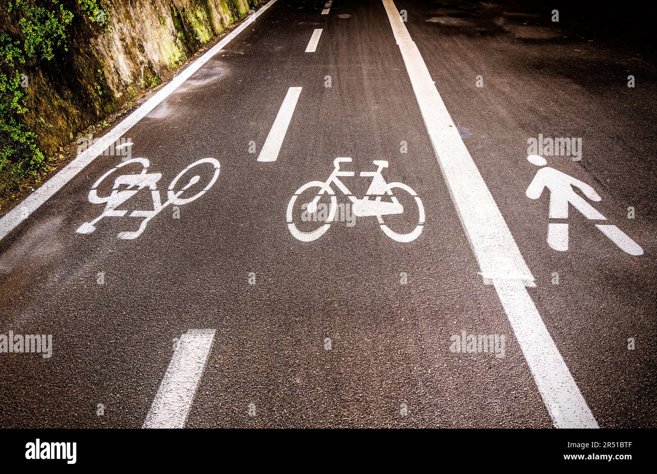 Bicycle and person sign on asphalt, Liguria Italy Stock Photo