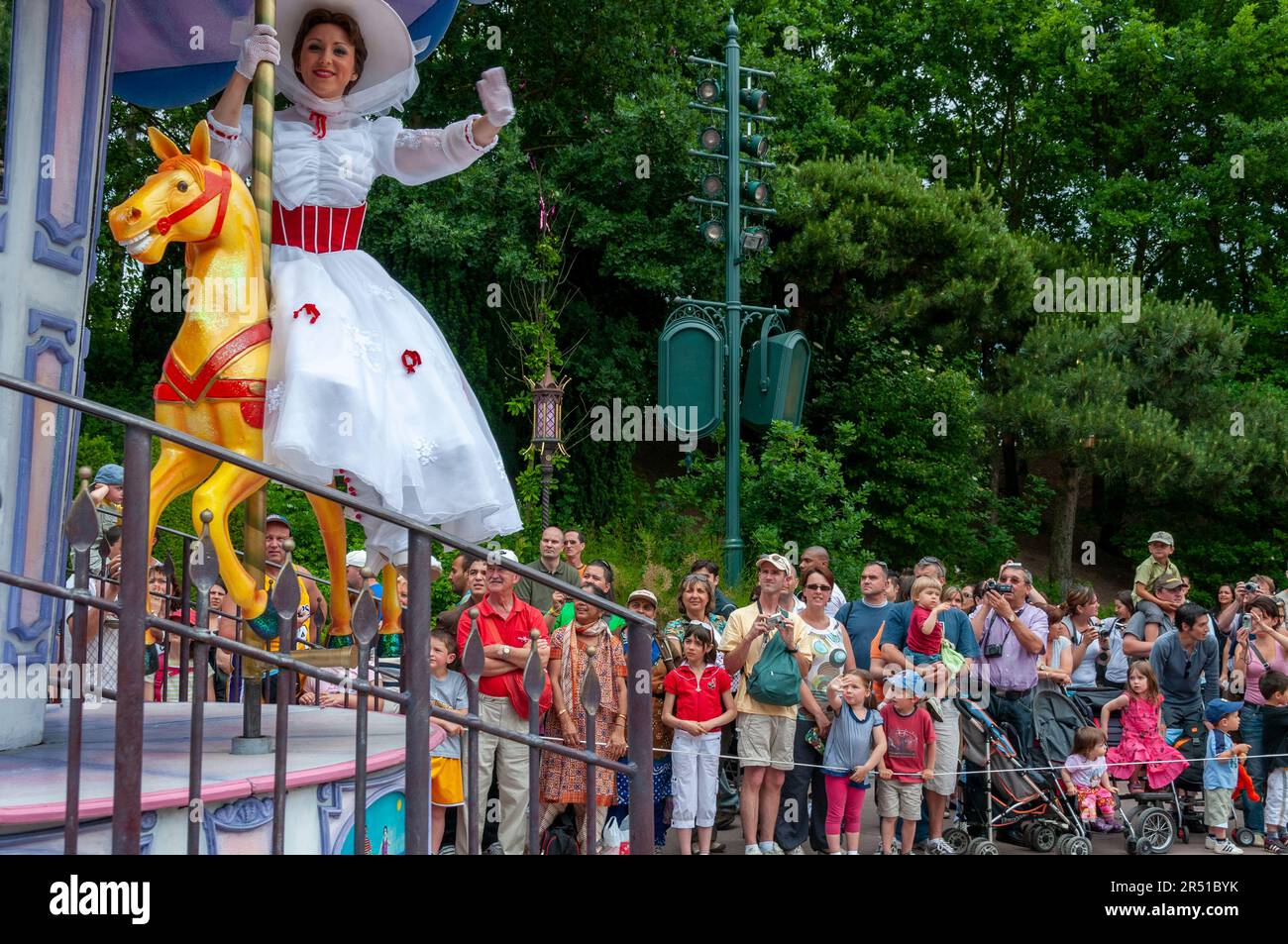 Paris, France, Theme Parks, People Visiting Disneyland Paris, Employee in Character Costume Entertaining Large Crowd Adults, at Disney Parade Stock Photo