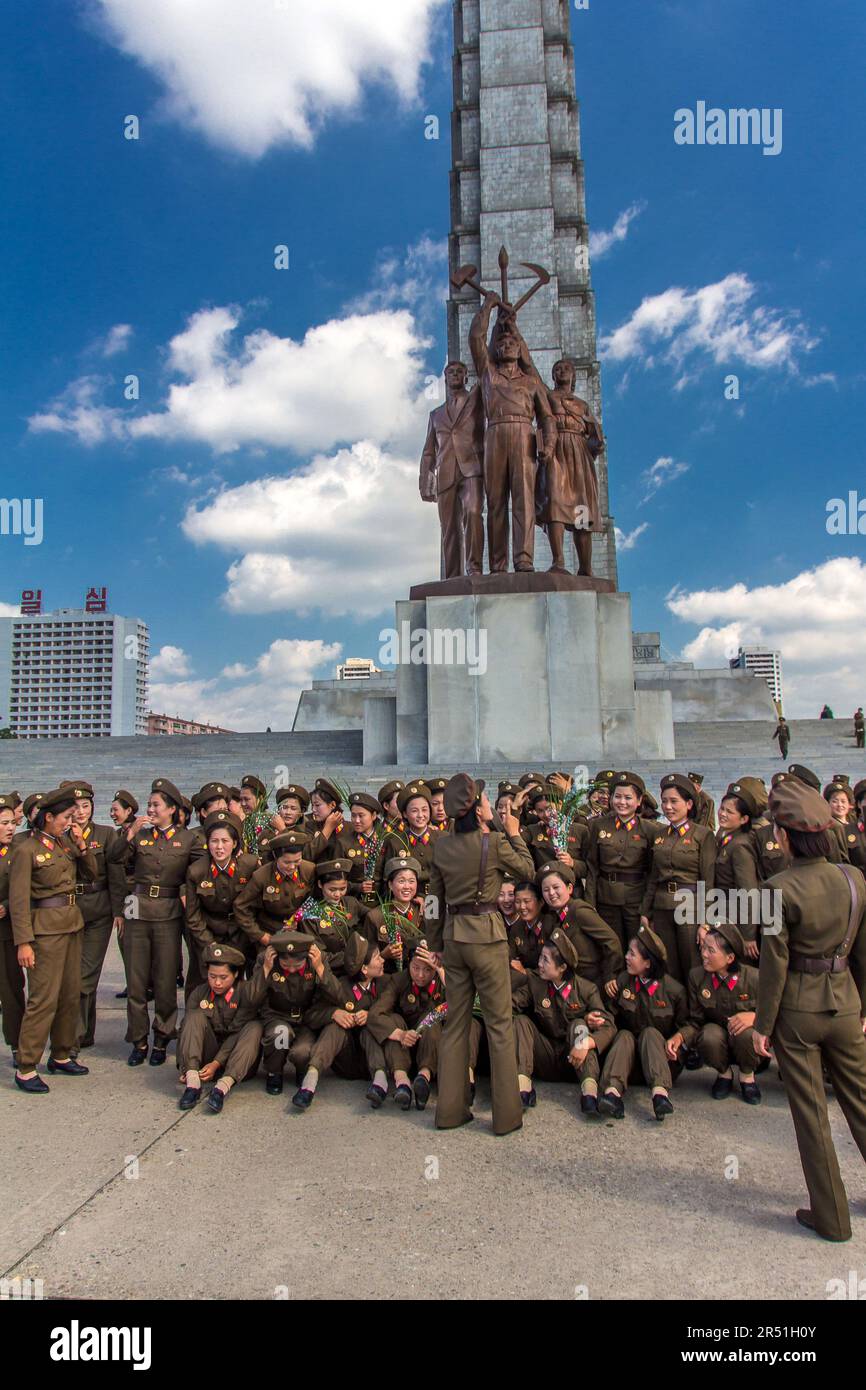 army women taking a picture in front of juche tower in north korea Stock Photo