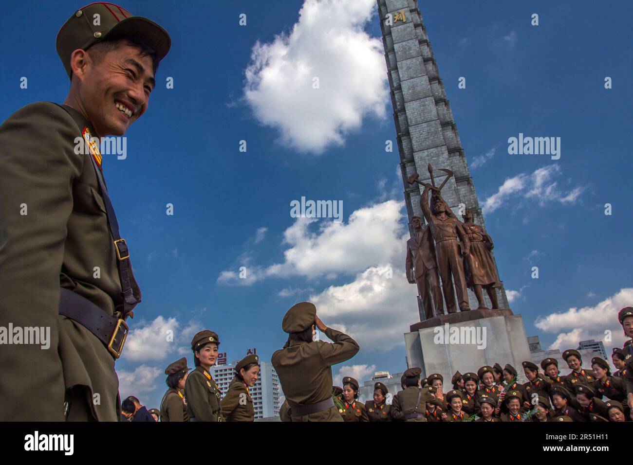 army women taking a picture in front of juche tower in north korea Stock Photo