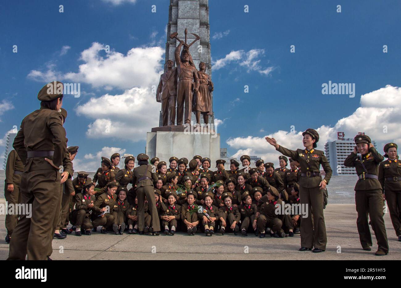 army women taking a picture in front of juche tower in north korea Stock Photo