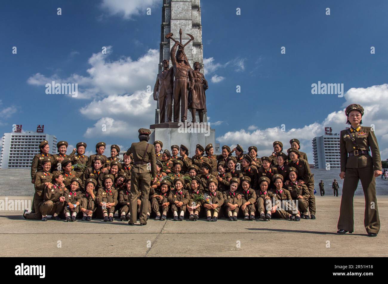 army women taking a picture in front of juche tower in north korea Stock Photo