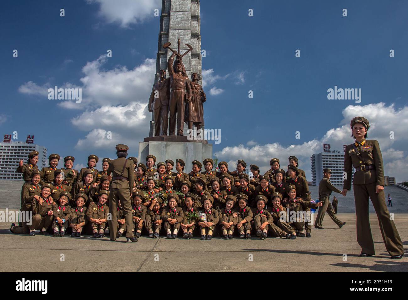 army women taking a picture in front of juche tower in north korea Stock Photo