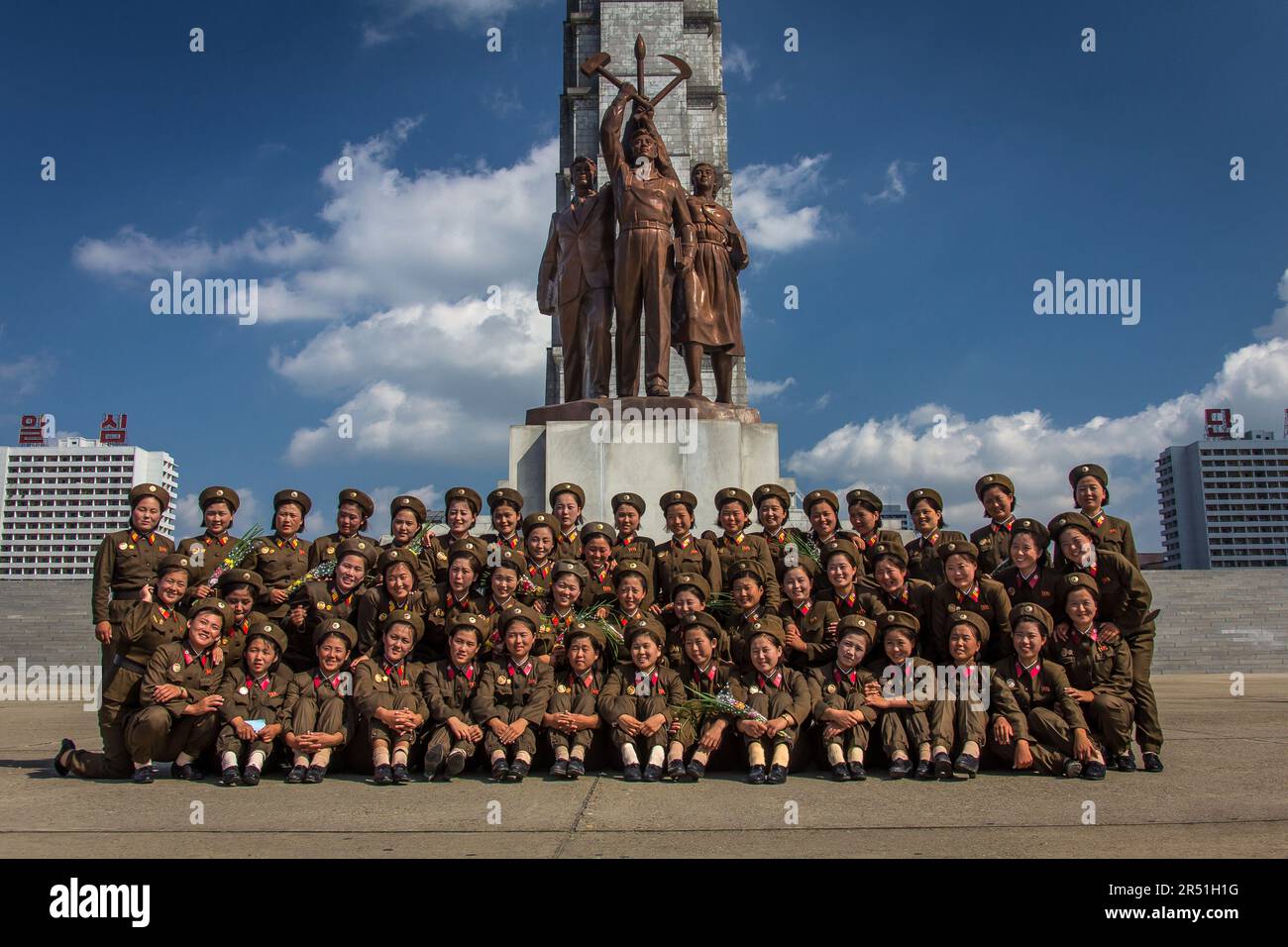 army women taking a picture in front of juche tower in north korea Stock Photo