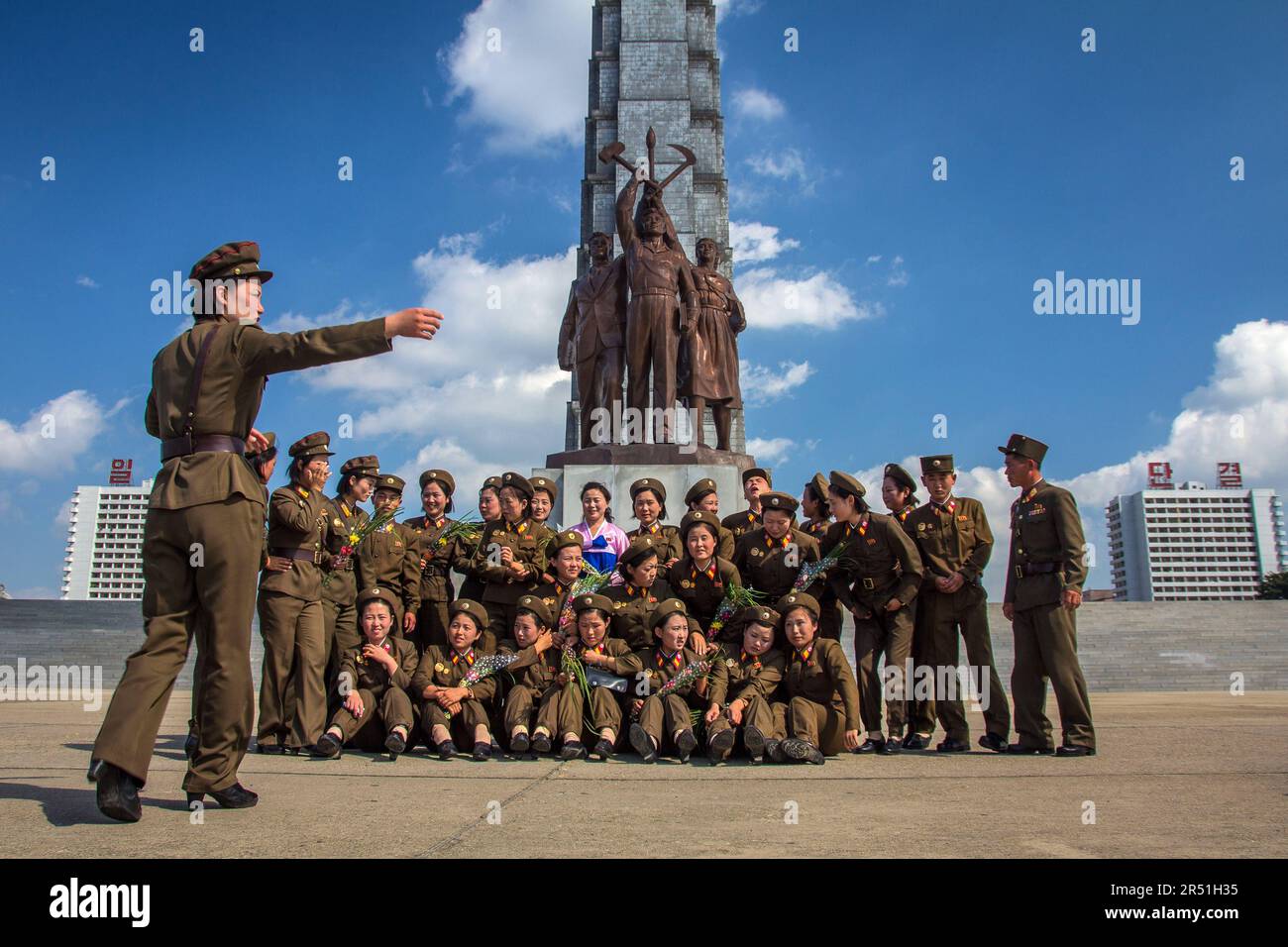 army women taking a picture in front of juche tower in north korea Stock Photo