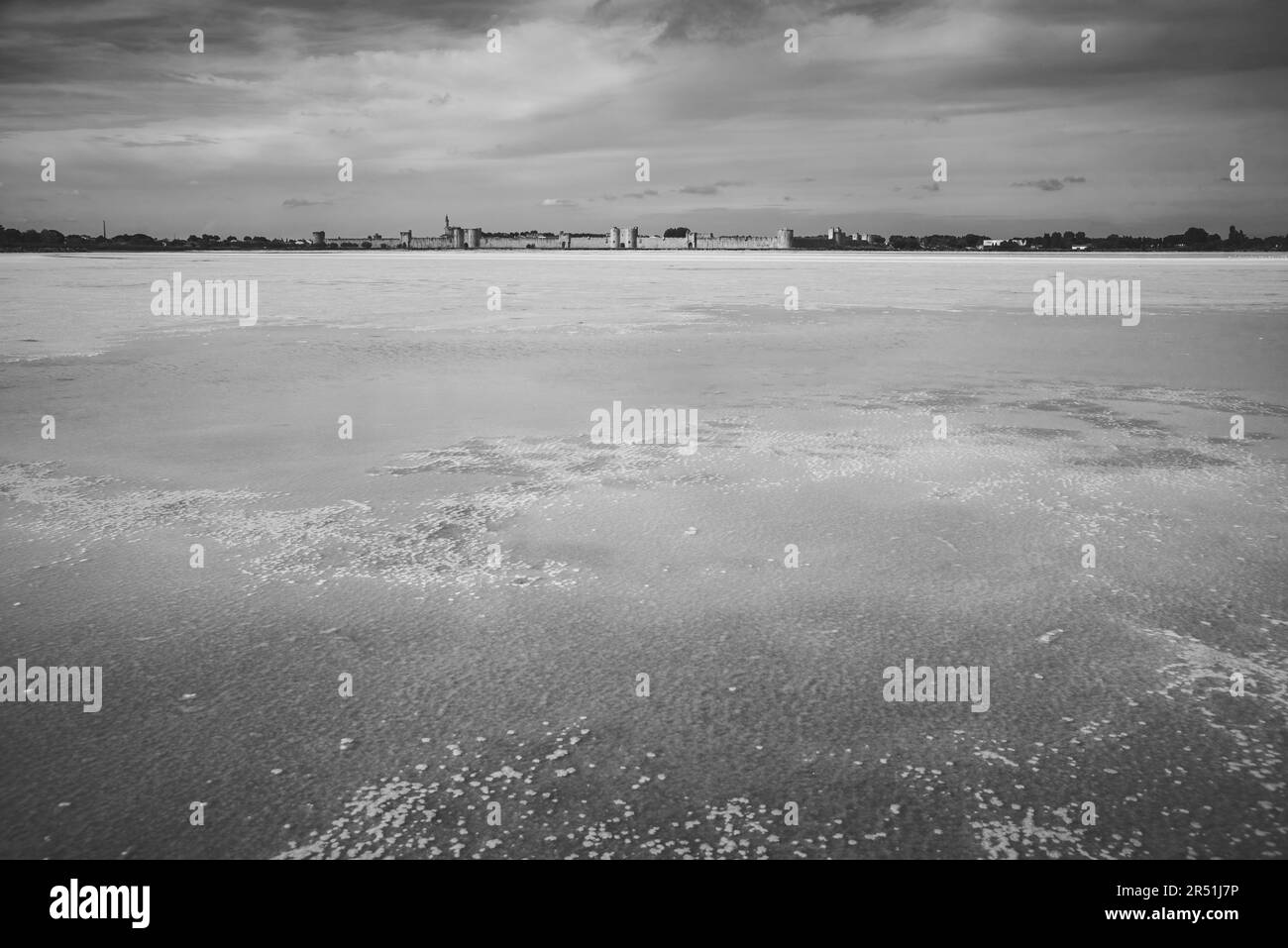 Dreamy landscape of salt lake near Aigues-Mortes, France. Medieval town