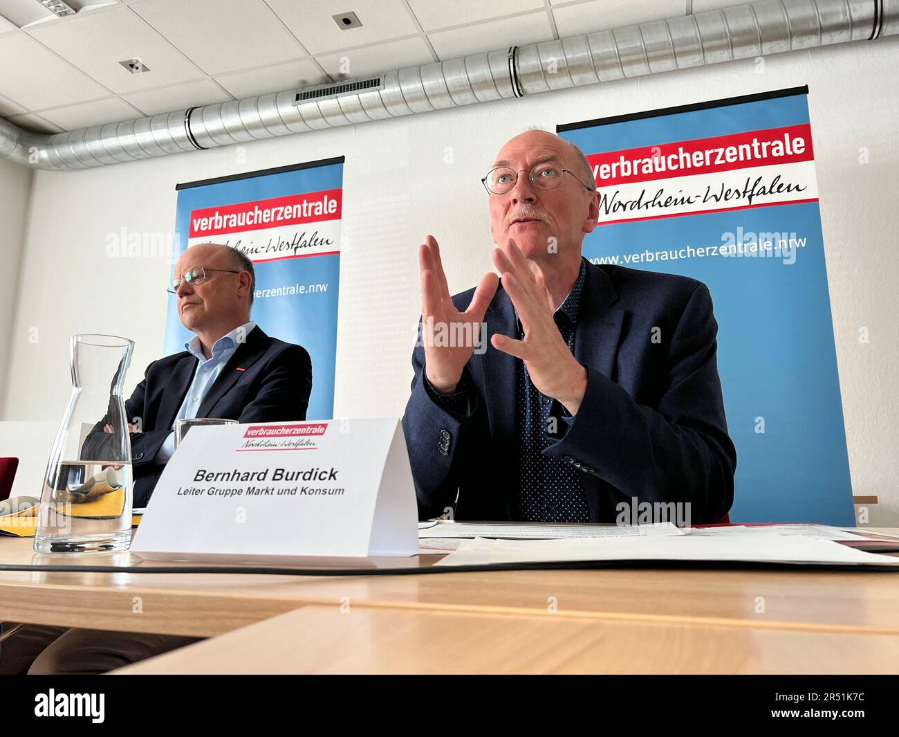Duesseldorf, Germany. 31st May, 2023. Bernhard Burdick (right), head of the Market and Consumption Group at the NRW Consumer Center, sits at a table during a press conference in one of his organization's rooms. To his left is Wolfgang Schuldzinski, head of the NRW consumer center. (to dpa: Consumer protectors criticize too high price differences in supermarkets) Credit: Wolf von Dewitz/dpa/Alamy Live News Stock Photo