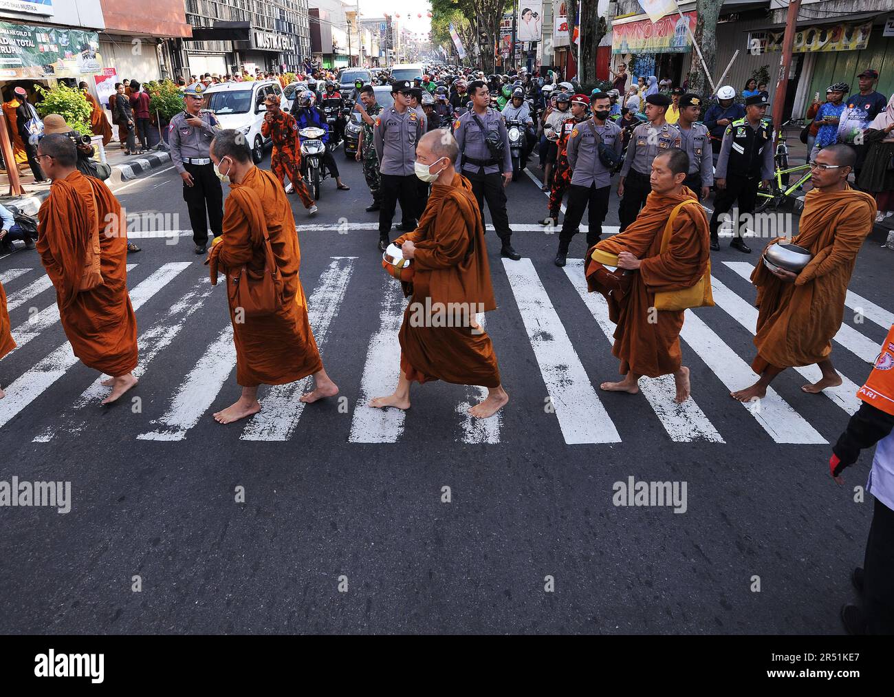 May 31, 2023, Magelang, Central Java, Indonesia: Monks from Thailand, Singapore, Malaysia, and Indonesia who perform the Thudong ritual on foot to Borobudur Temple, go for alms at the Liong Hok Bio Temple in Magelang, Central Java. In Magelang City, the monks received a friendly welcome from the locals. around waiting on the side of the road for the Pindapata tradition which was stopped for 3 years, Pindapata is a Buddhist tradition of giving alms to monks or priests in the form of food, money, and various daily needs. The 32 monks are scheduled to continue their final journey to Borobudur Tem Stock Photo