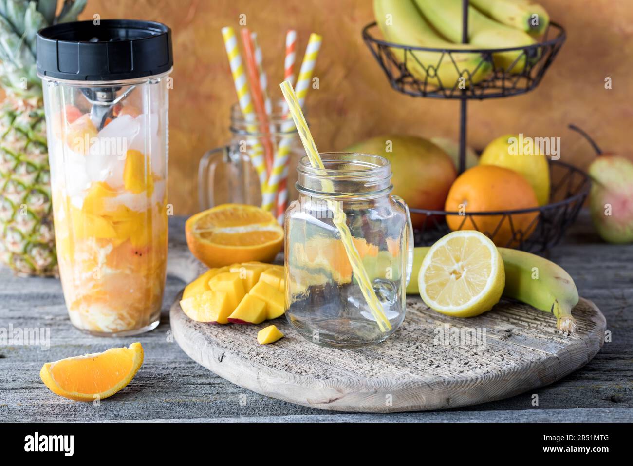 Ingredients of a mango citrus smoothie in a blender container ready for