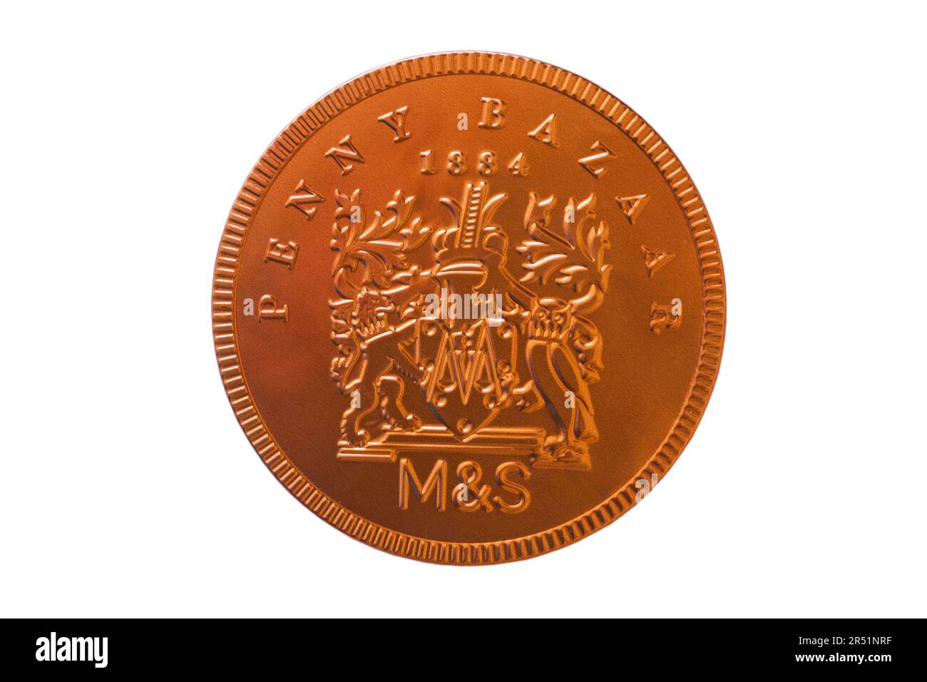 large Penny Bazaar 1884 foil wrapped milk chocolate coin from M&S isolated on white background Stock Photo