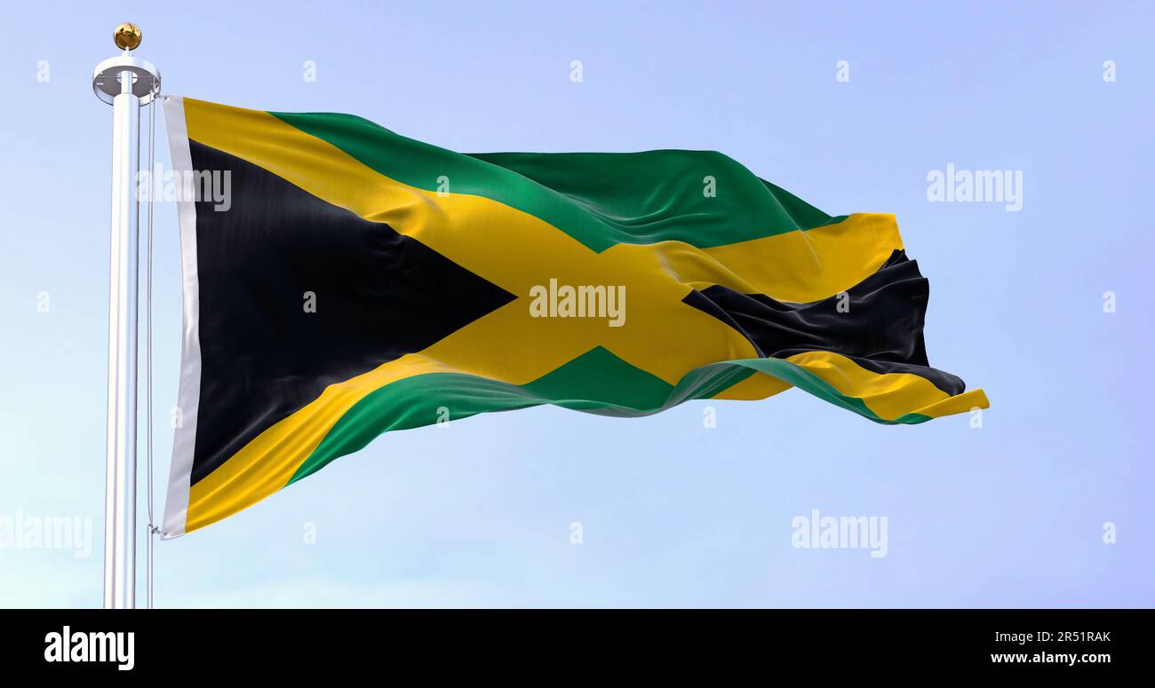 Jamaica national flag waving in the wind on a clear day. Gold saltire dividing it into four sections: two green and two black. 3d illustration render. Stock Photo