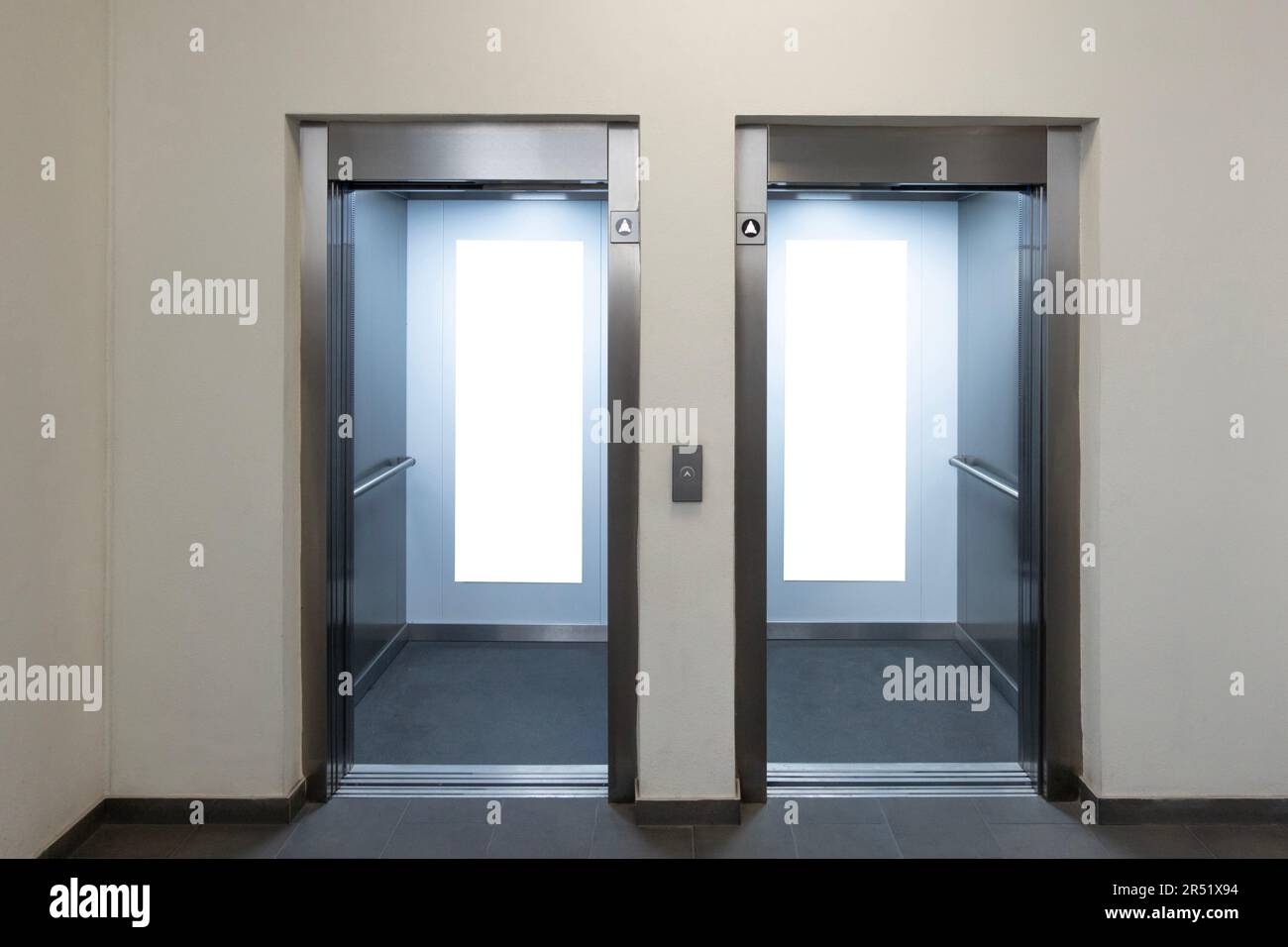 Mock up. Two empty elevators with opened metallic cabins doors and