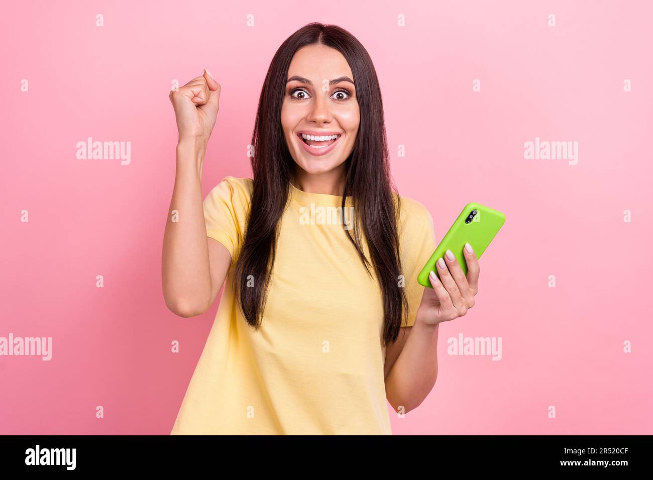 Photo of sweet lucky lady wear yellow t-shirt chatting instagram twitter  telegram facebook isolated pink color background Stock Photo - Alamy