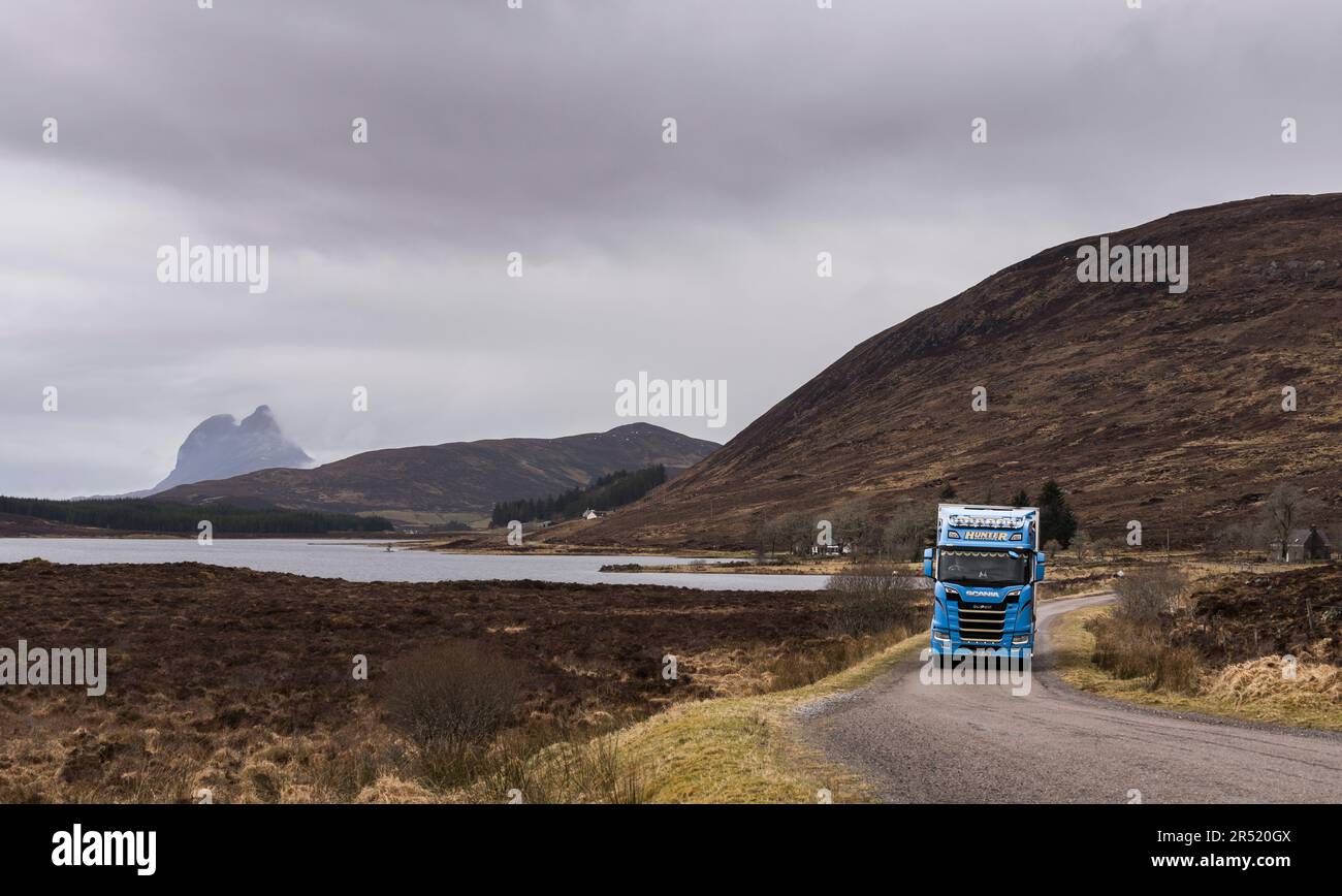 Suilven mountain and Loch Borralan under cloudy sky with blue heavy ...