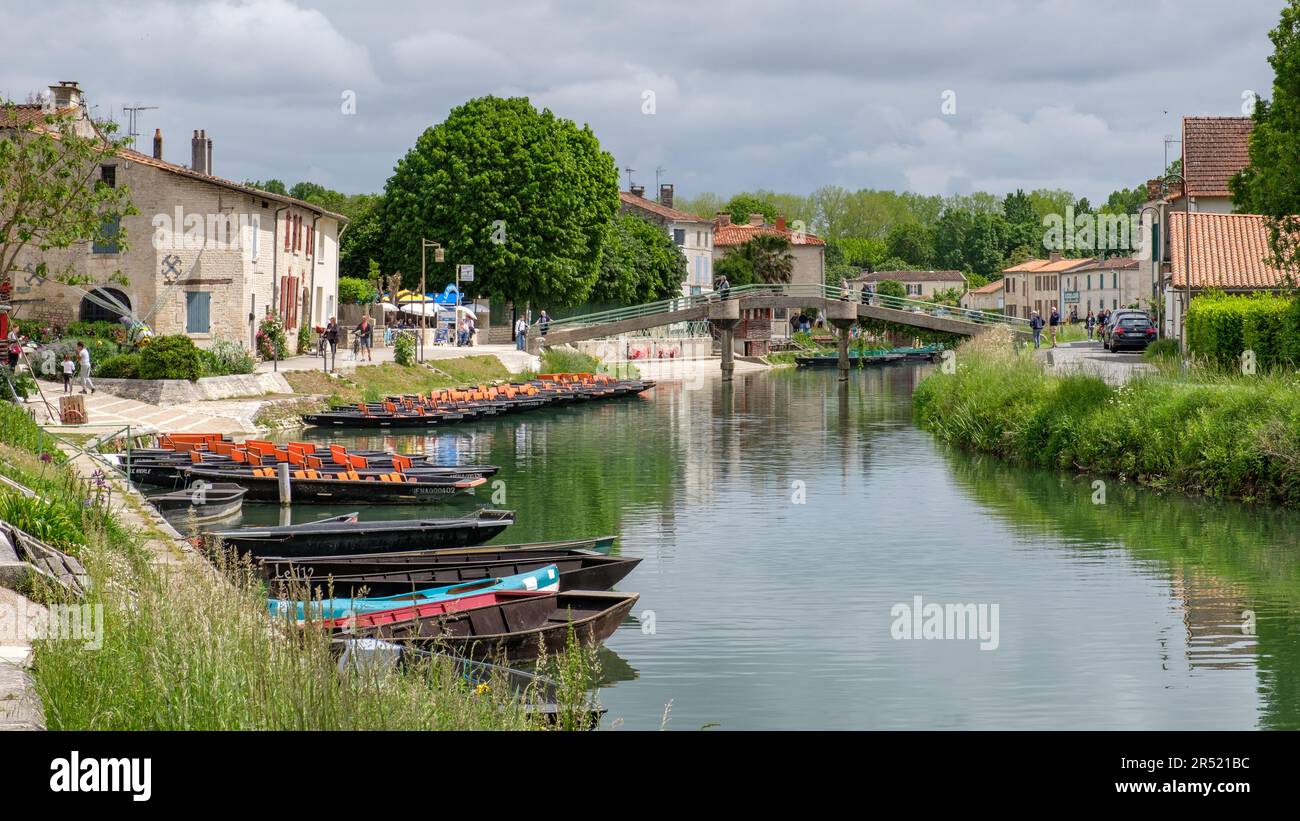 Boats on the Sevres Niortaise river in Coulon ready to explore the Marais Poitevin Stock Photo