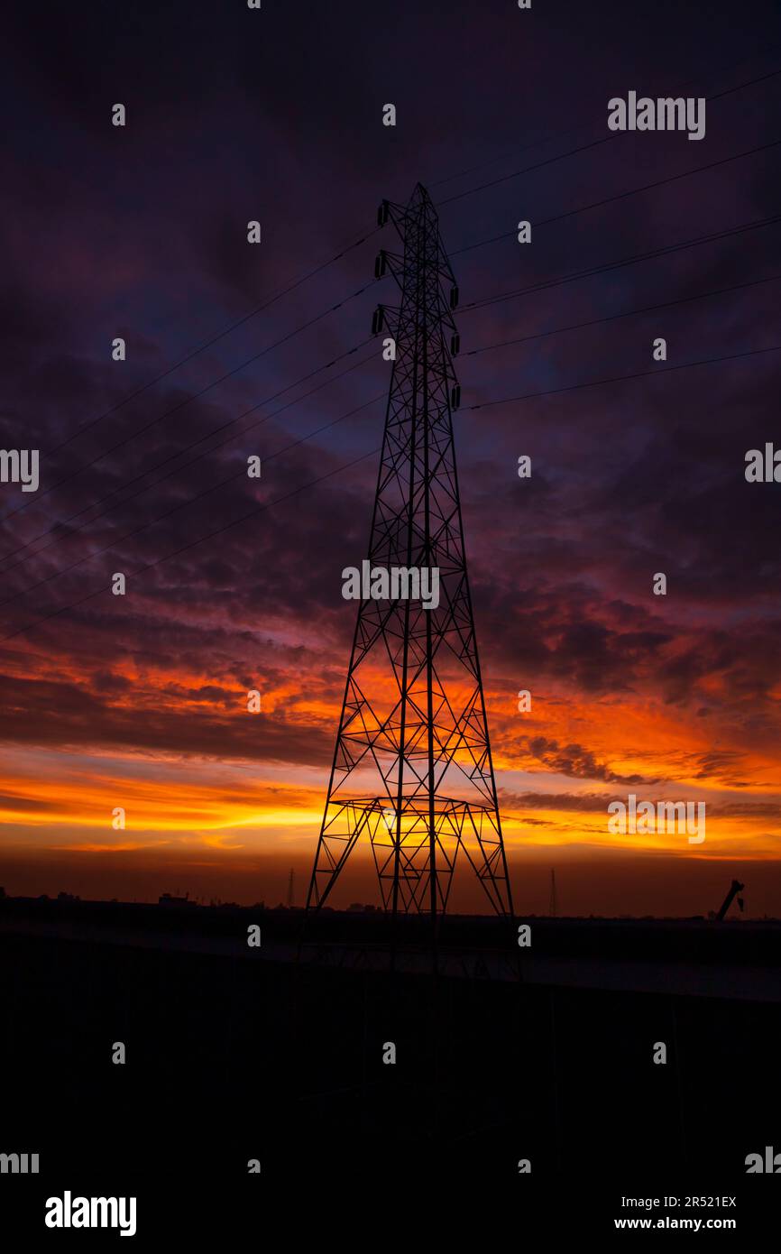 High voltage power line tower with beautiful sky at sunset, stock photo ...