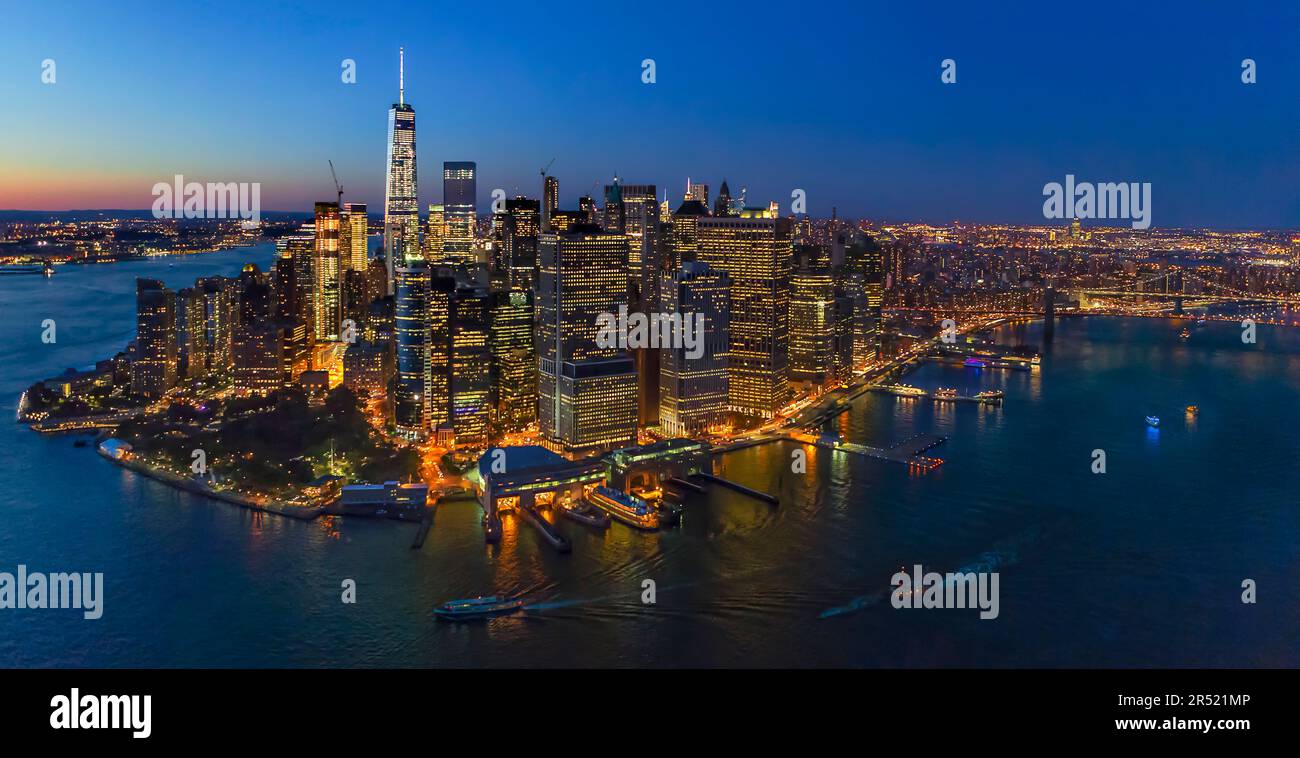 Illuminated Lower Manhattan NYC - Aerial panoramic view during the blue hour at twilight of the lower Manhattan section of New York City. Commanding r Stock Photo