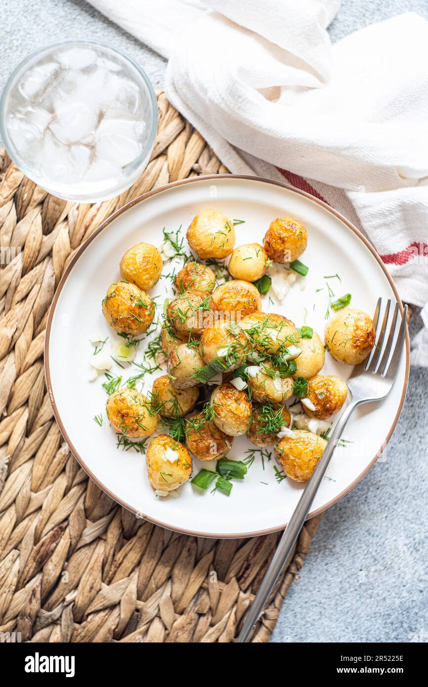 From above fried spring potato vegetables with herbs served in the bowl for lunch Stock Photo