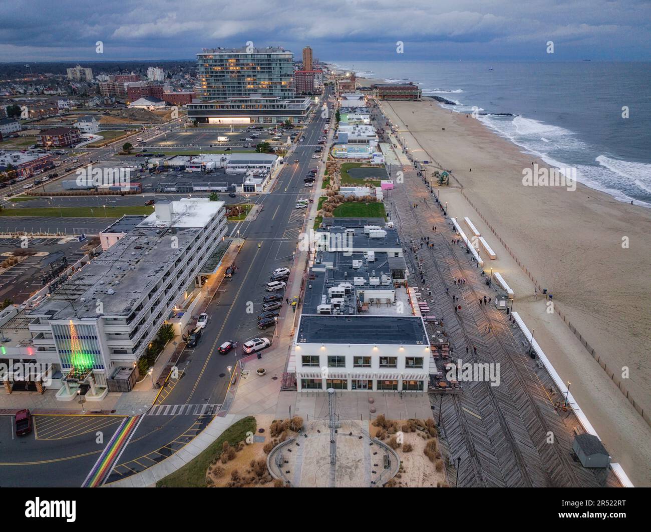 Asbury Park Boardwalk Aerial - Aerial view to the historic Asbury Park's Carousel House with Asbury Park Beach and boardwalk in the background.  This Stock Photo
