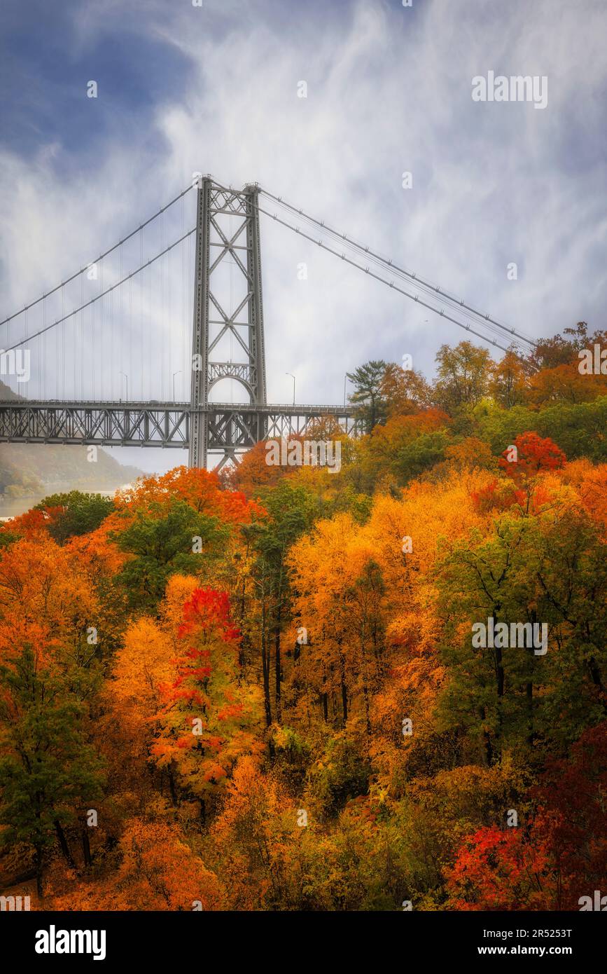 View Bear Mountain Bridge State Park during the peak of fall foliage. The Popolopen footbridge is also seen from this upper view of this Hudson Valley Stock Photo