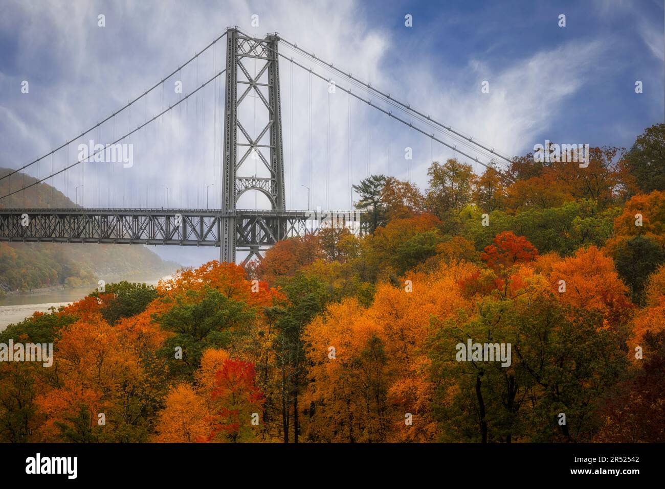 View Bear Mountain Bridge State Park during the peak of fall foliage. The Popolopen footbridge is also seen from this upper view of this Hudson Valley Stock Photo