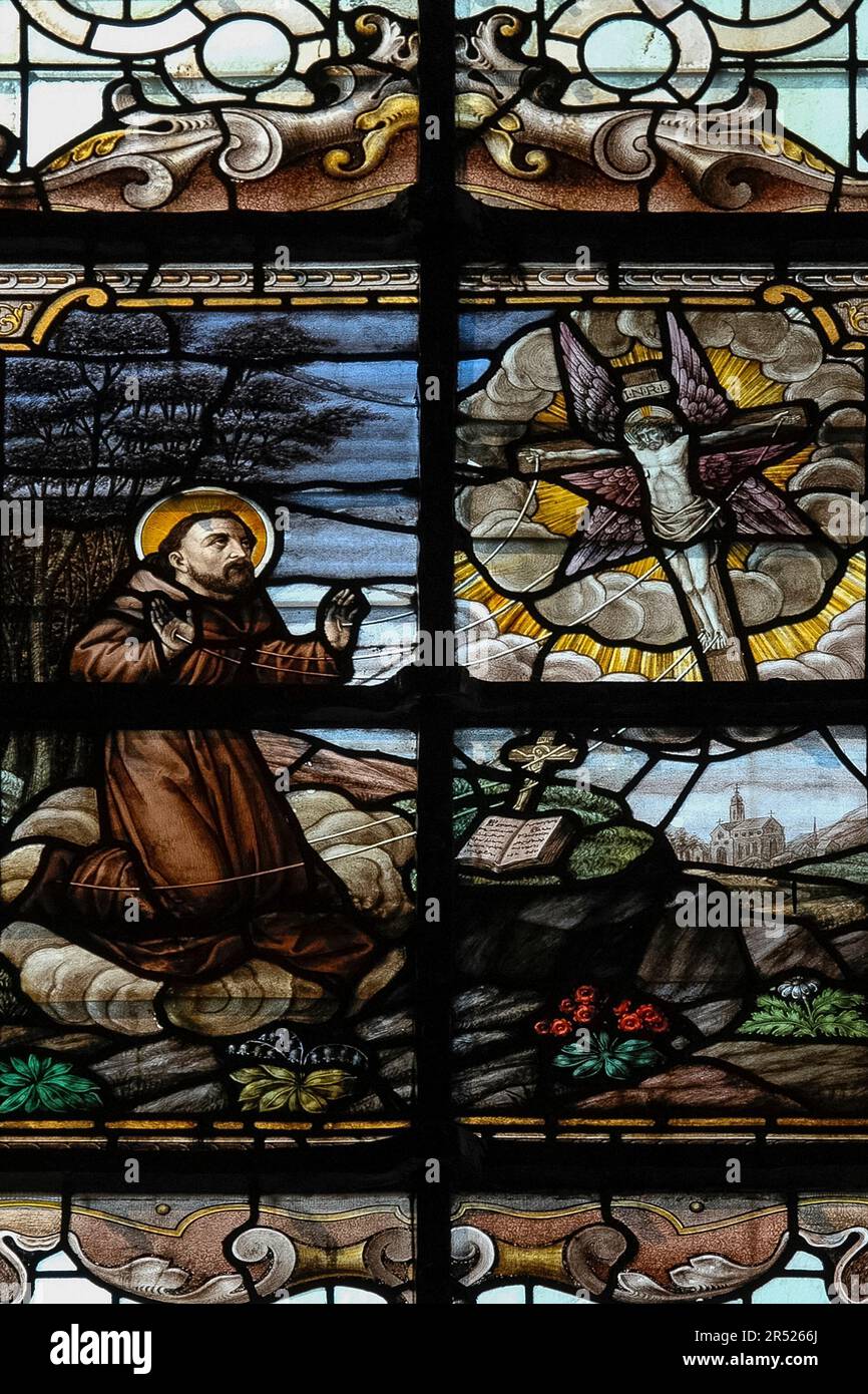 Saint Francis of Assisi receiving the stigmata.  Depicted in stained glass in a church dedicated to St Elizabeth of Hungary, the Begijnhofkerk Sint Elisabeth, which serves the Béguinage or Begijnhof, a walled religious house, in Bruges, West Flanders, Belgium. Stock Photo