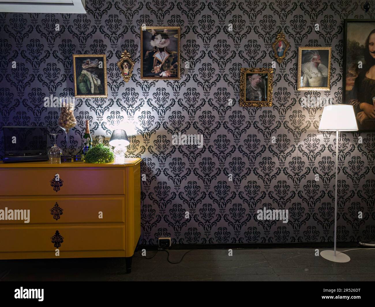 Room filled with colorful furniture, enhanced by vintage wallpaper